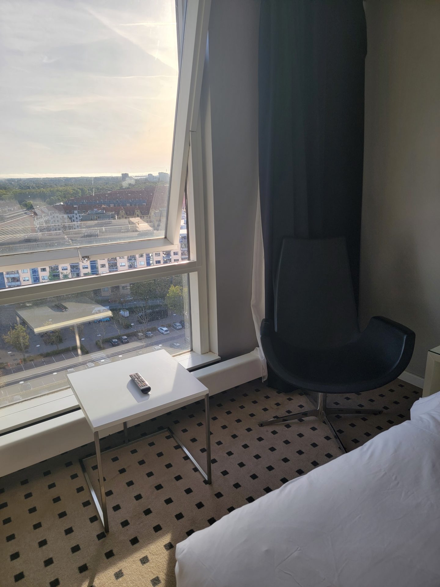 a room with a window and a bed and a chair