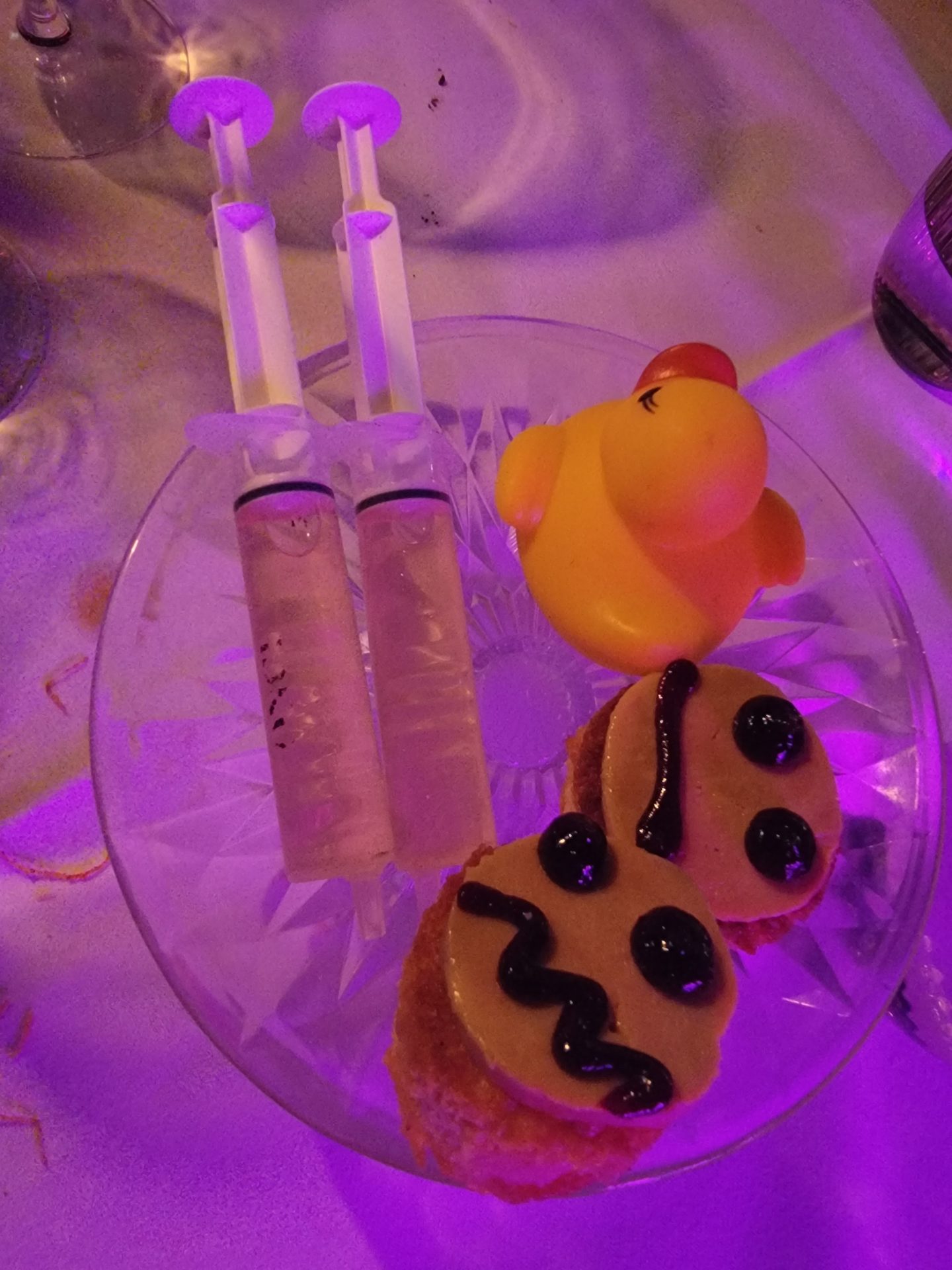 a plate with food and syringes on it