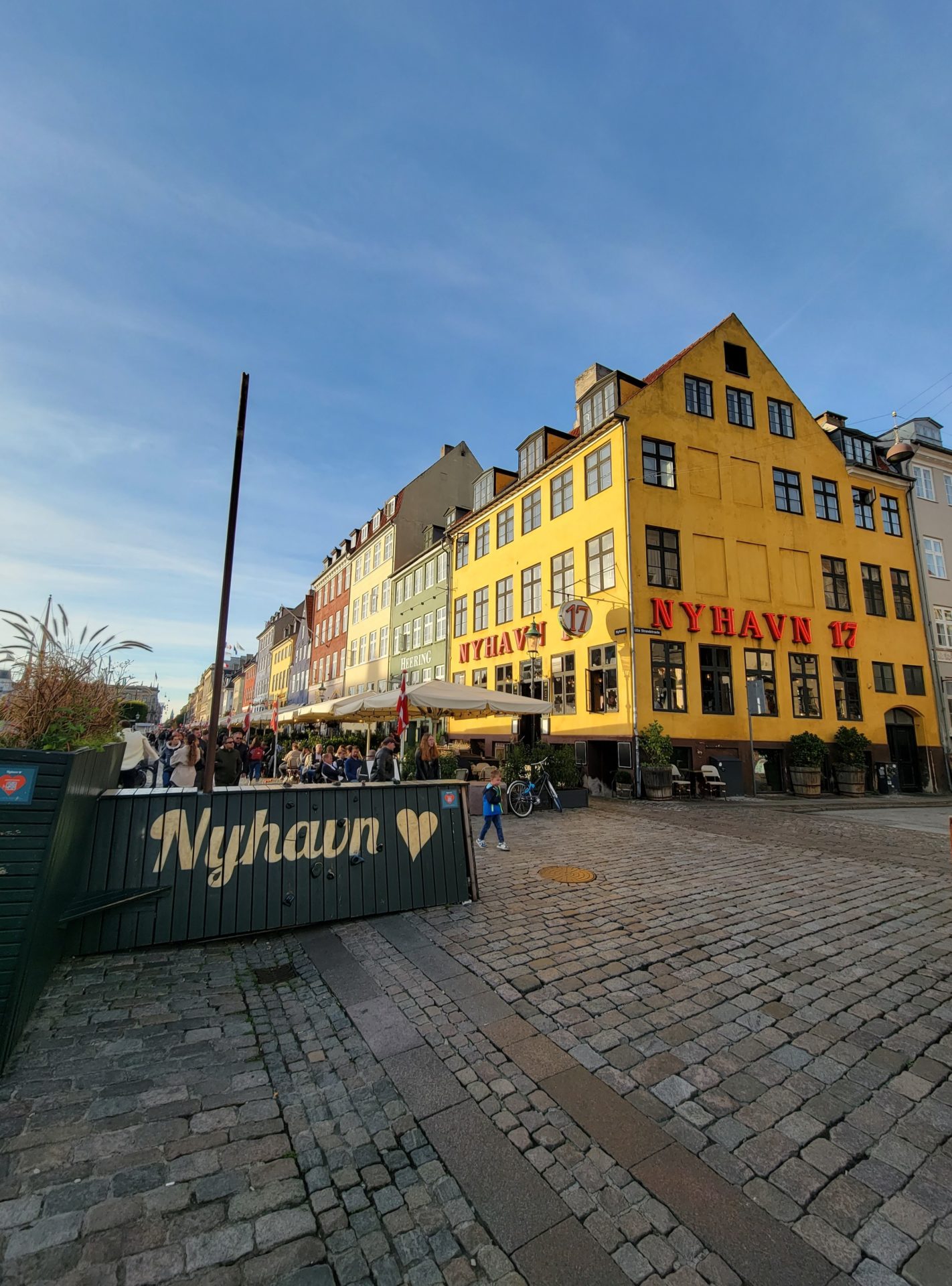 a yellow building with people walking around