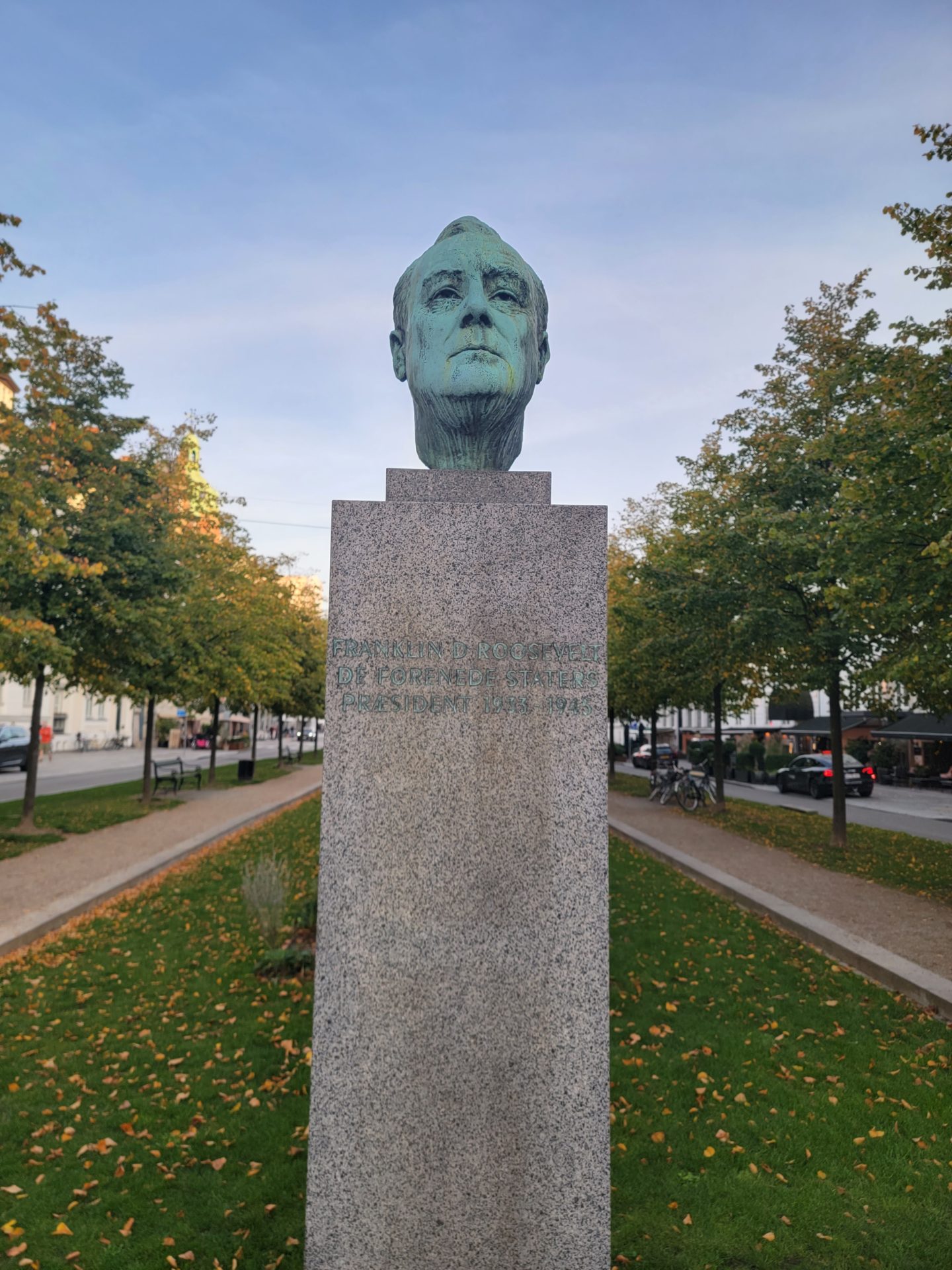 a statue of a man's head on a stone pedestal