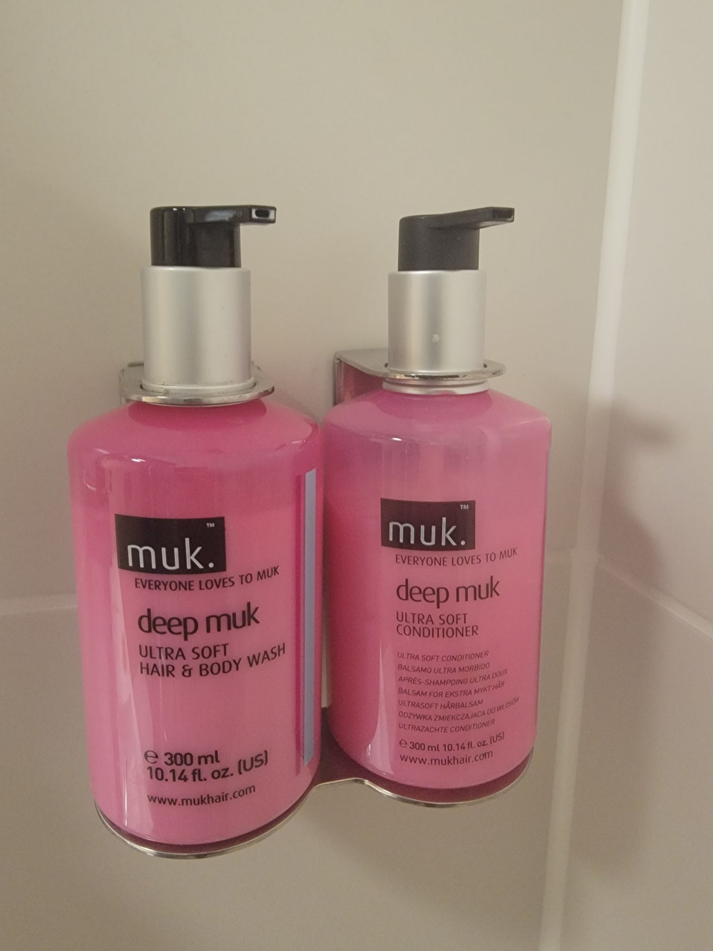 a couple of pink bottles of shampoo