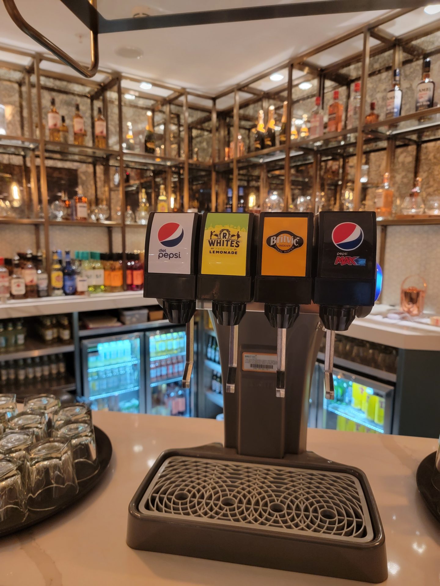 a soda dispenser in a bar