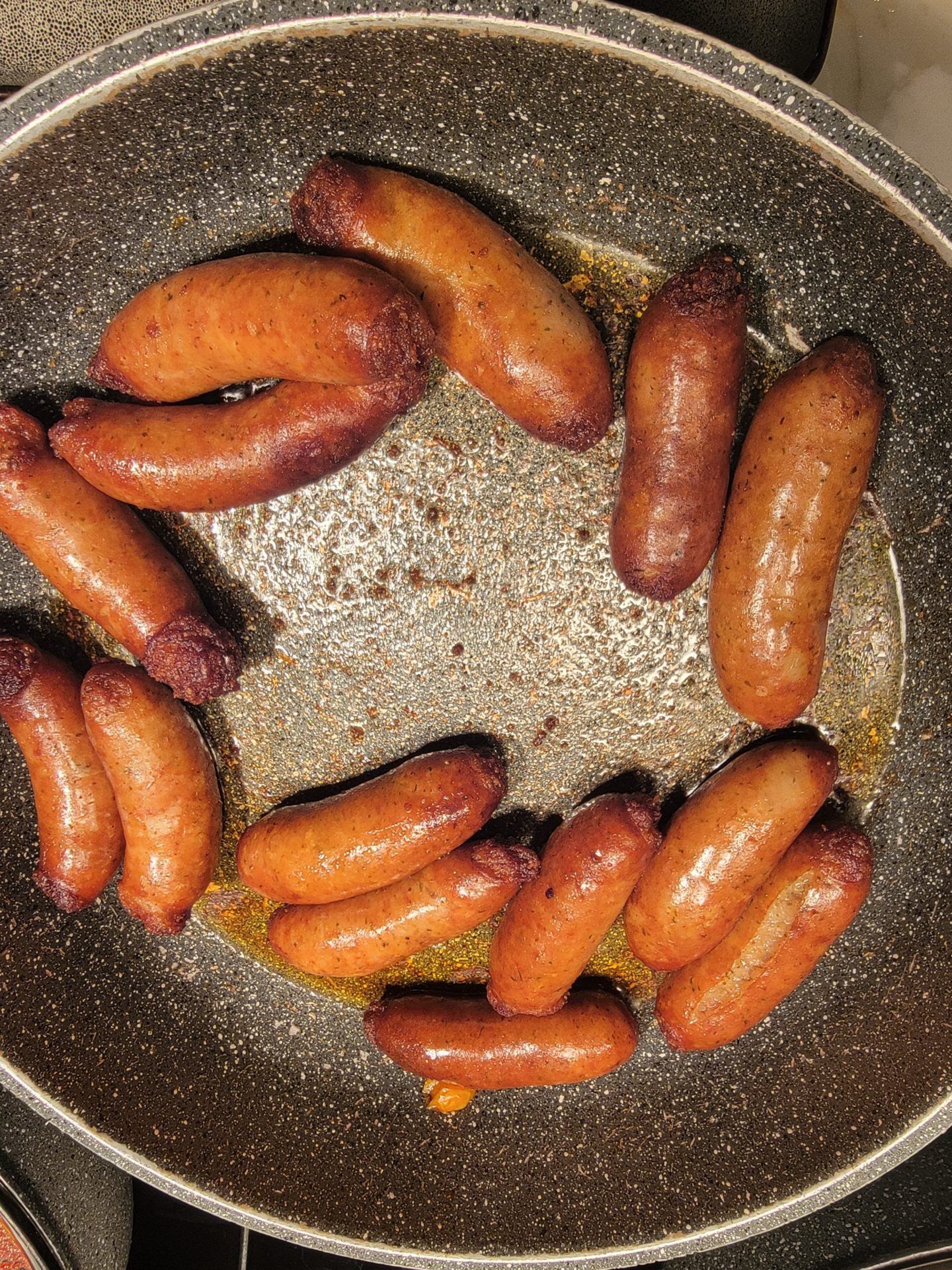 sausage sausages cooking in a pan