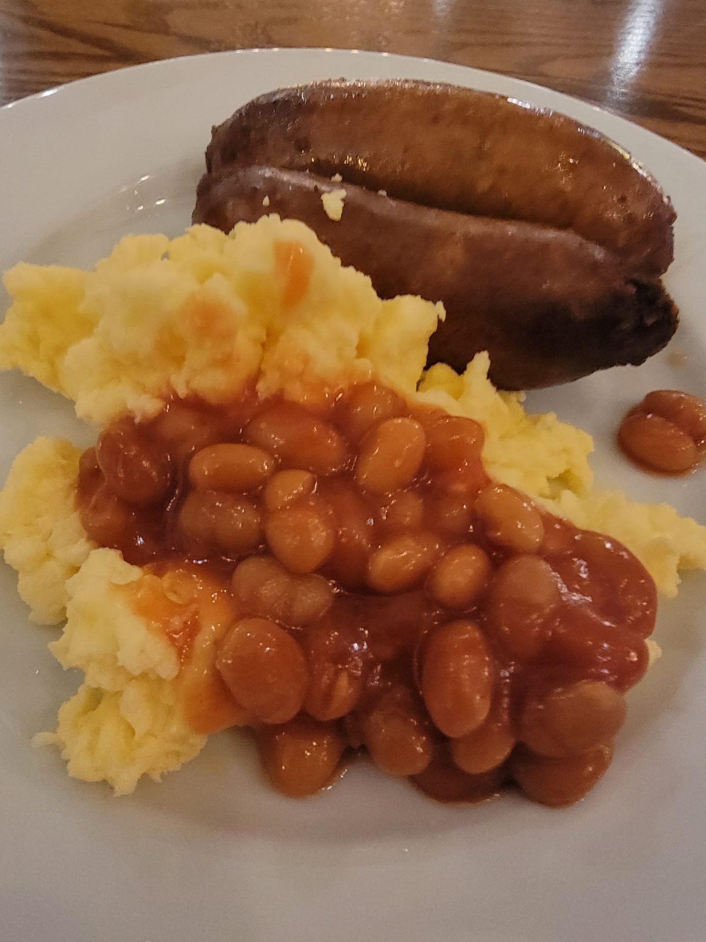 a plate of food with beans and potatoes