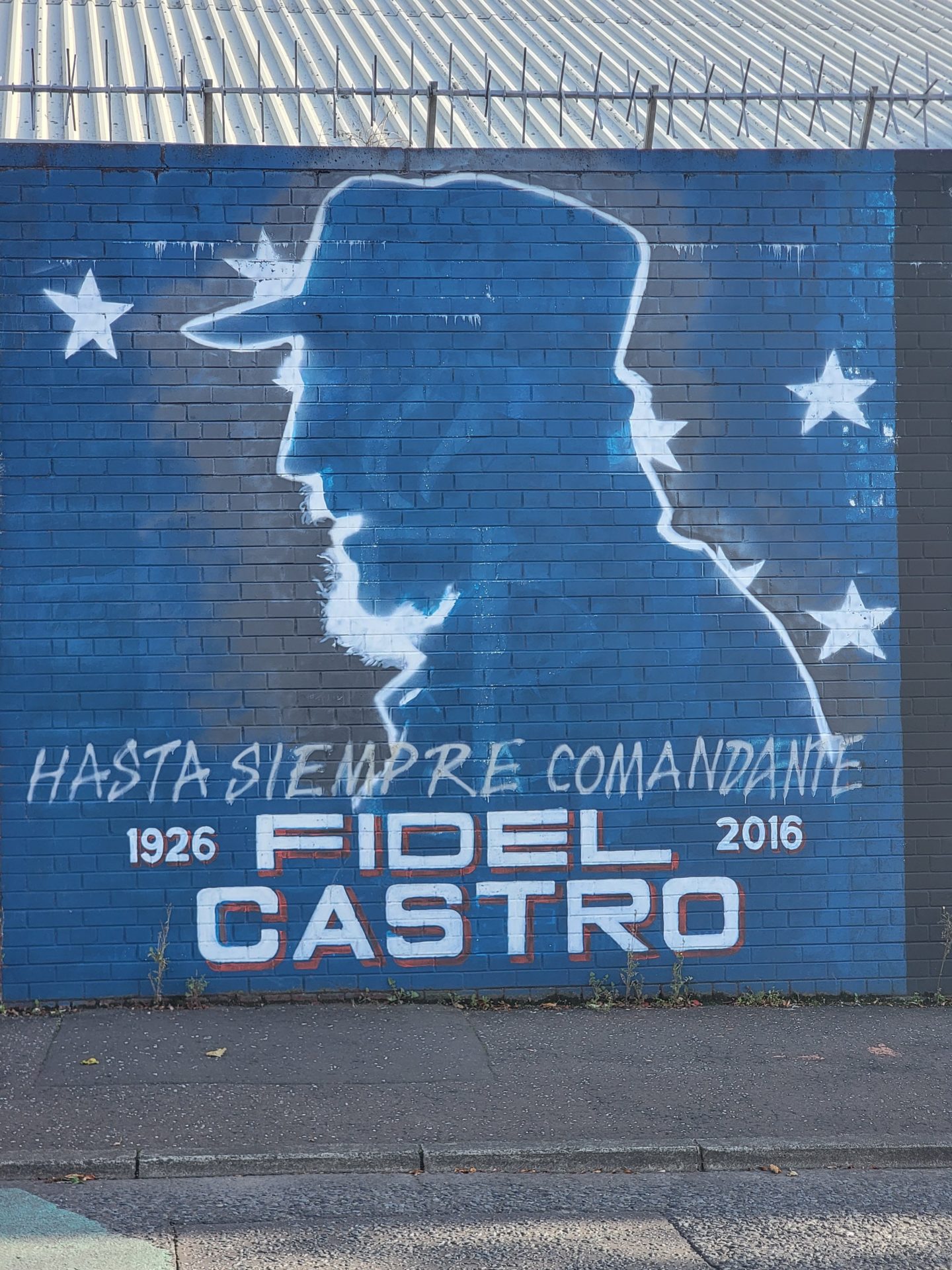 a blue wall with a man's head and white text