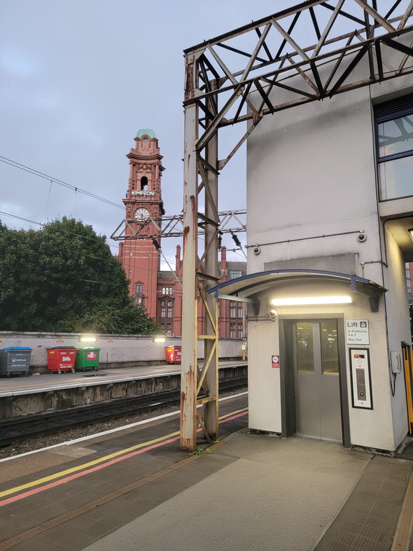 a train station with a clock tower in the background
