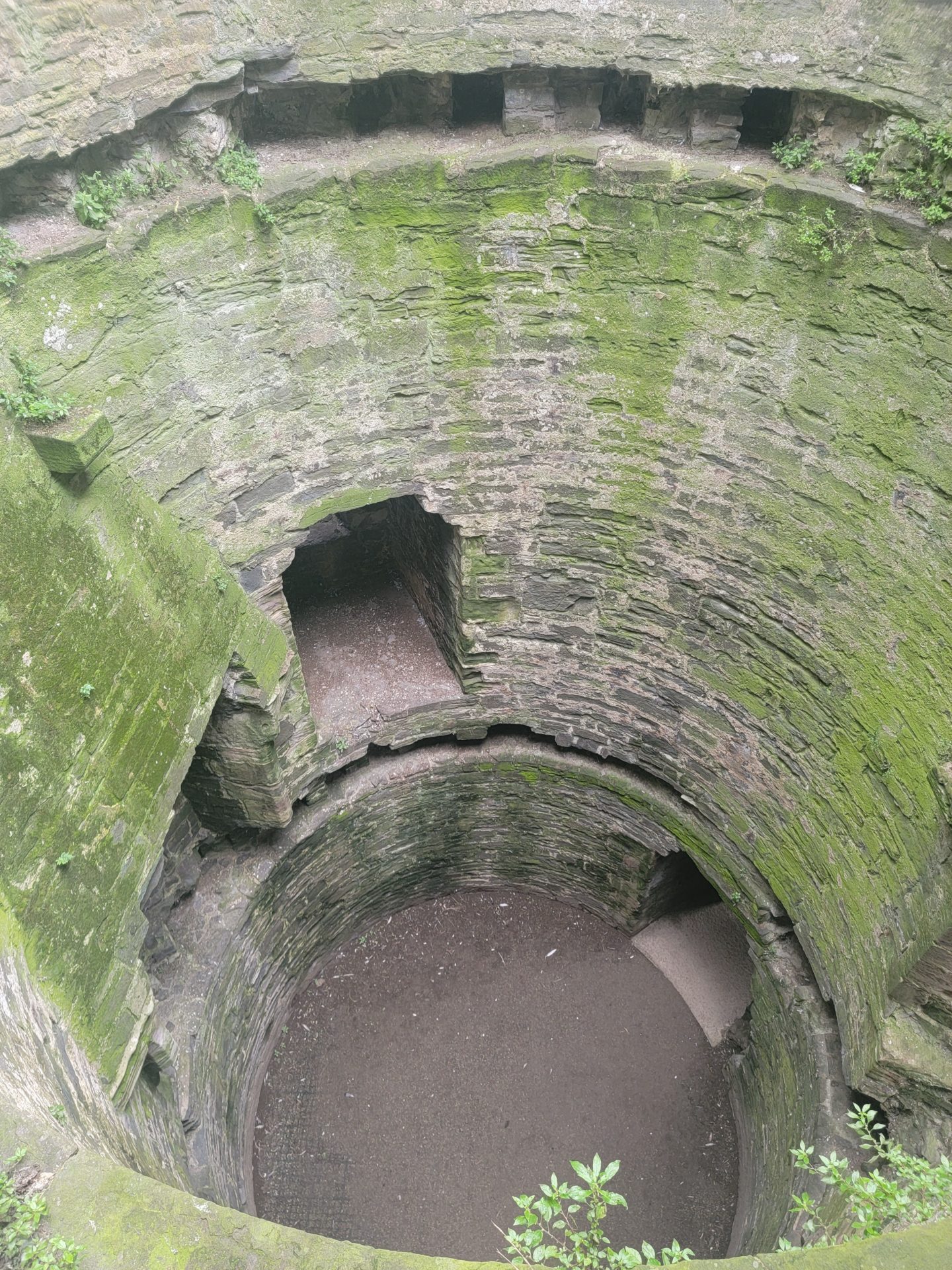 a stone well with a hole in it