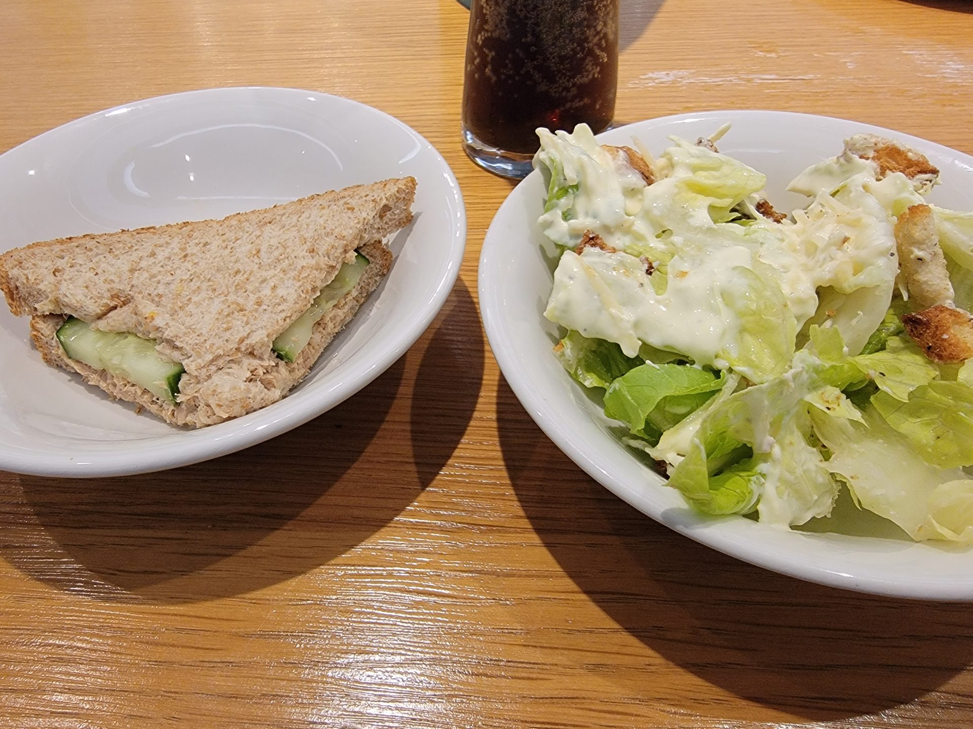 a sandwich and salad in a bowl