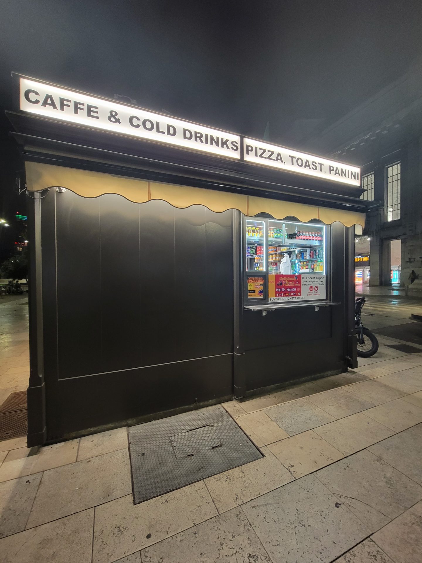 a small black building with a sign on it