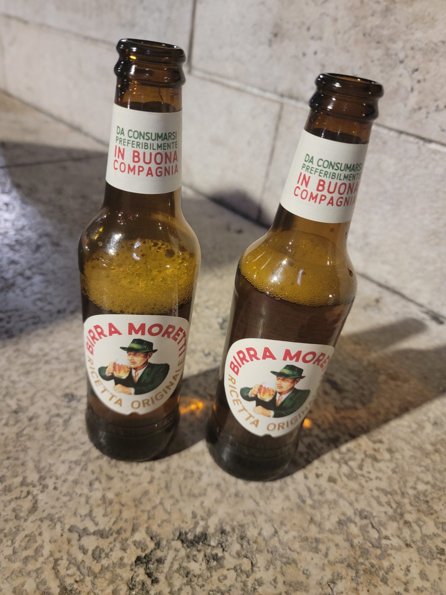 two brown bottles with white labels on them