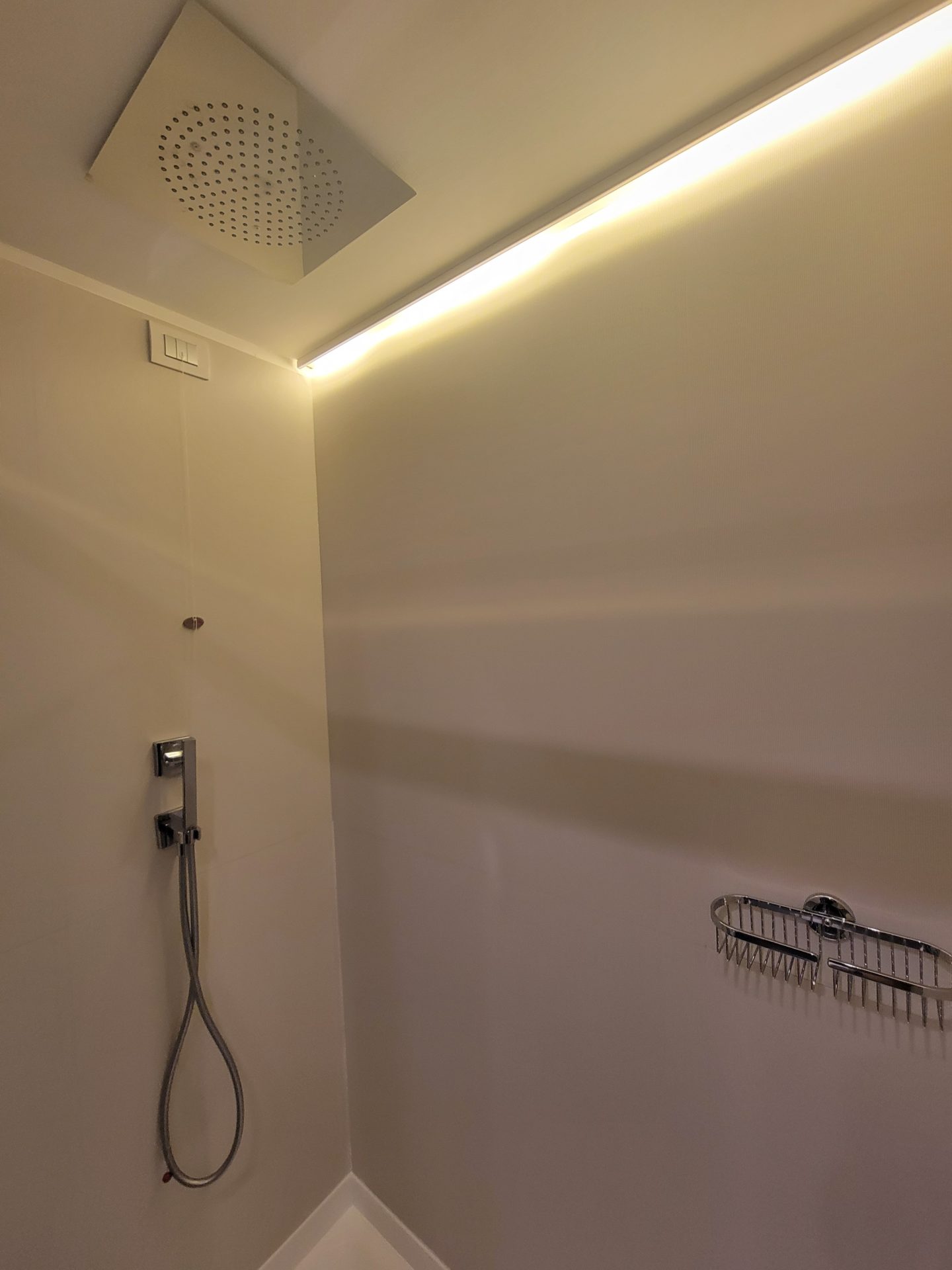 a shower with a shower head and a shower head