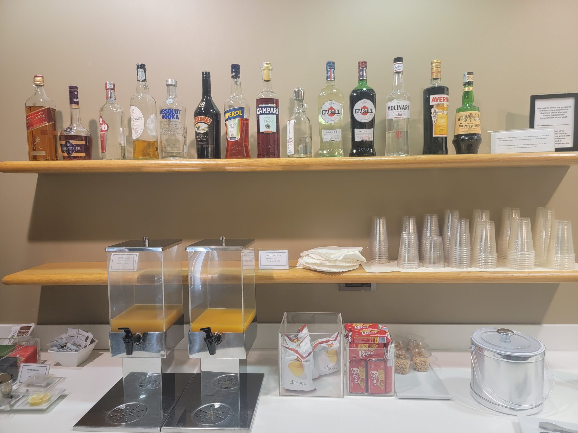 a shelf with bottles and cups on it