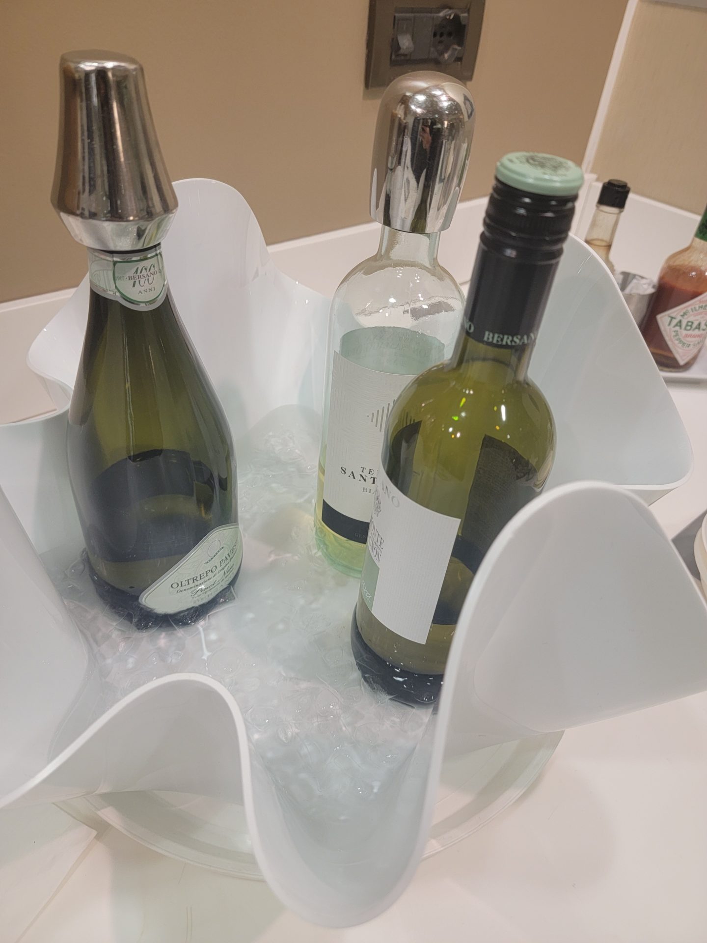 a group of bottles in a white bowl