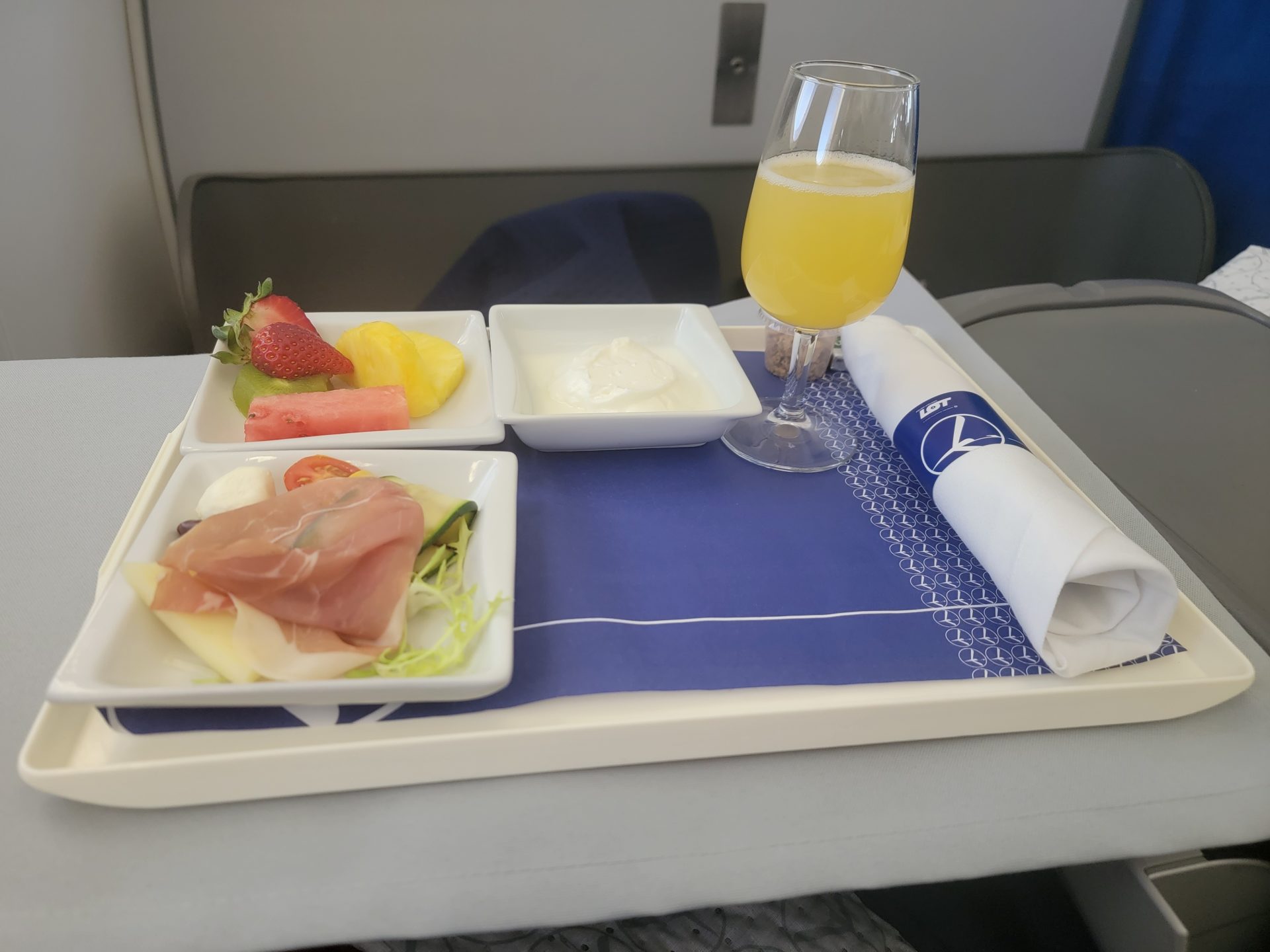 a tray with food and a glass of juice on it