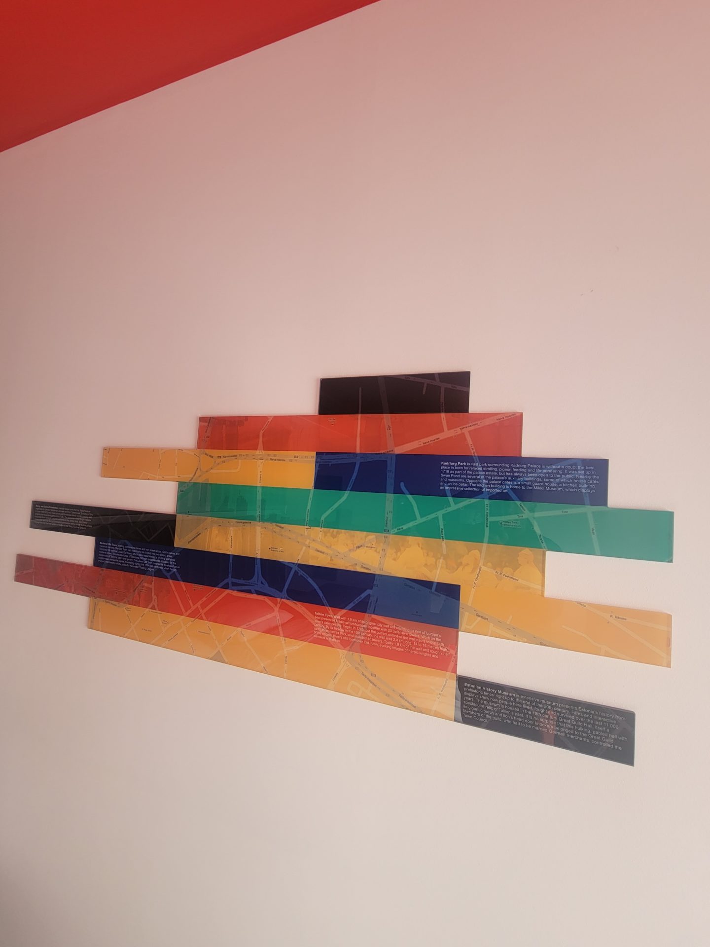 a group of colorful rectangular objects on a white wall