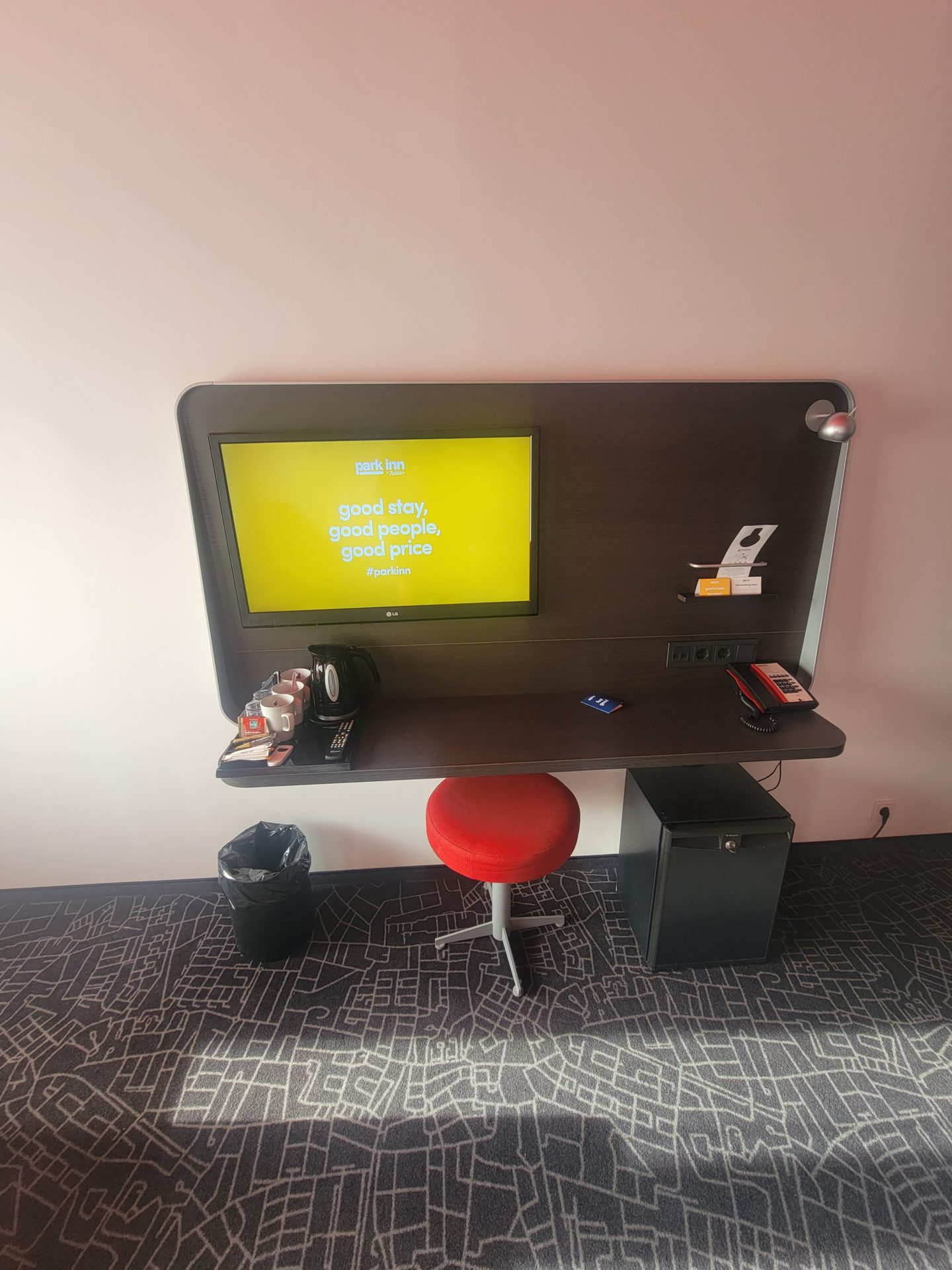 a desk with a screen and a chair