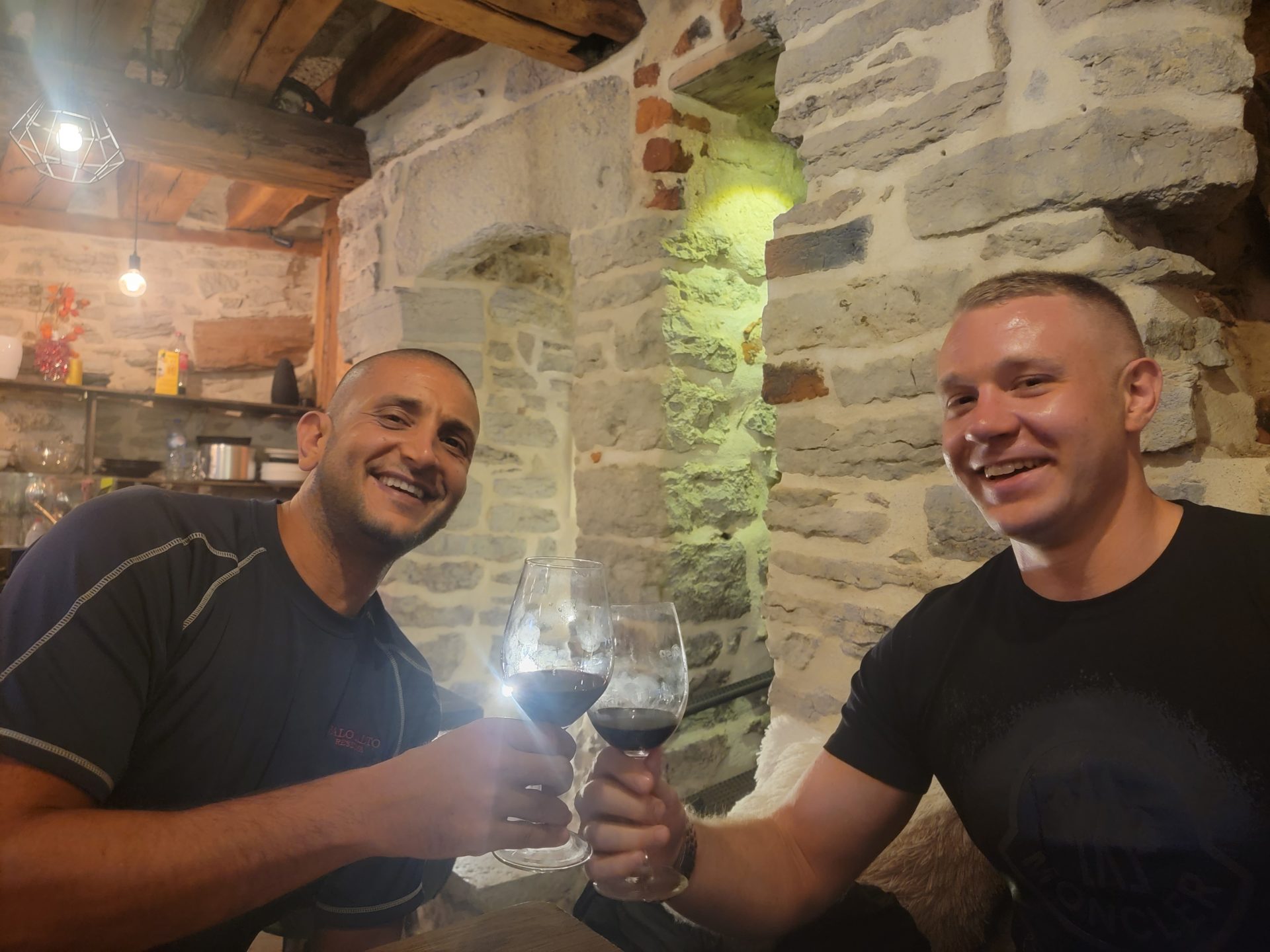 two men holding wine glasses
