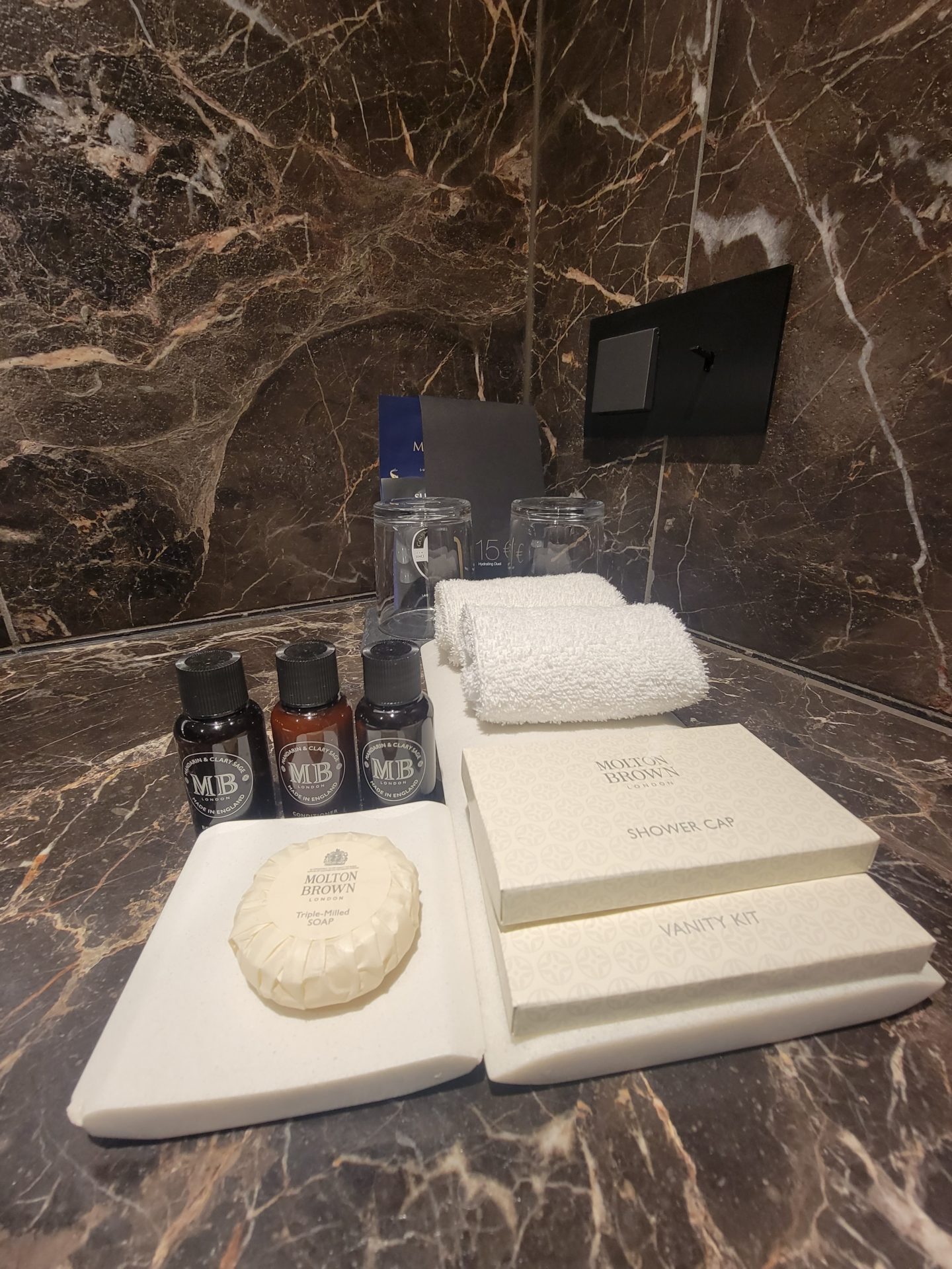 a bathroom counter with a towel and toiletries