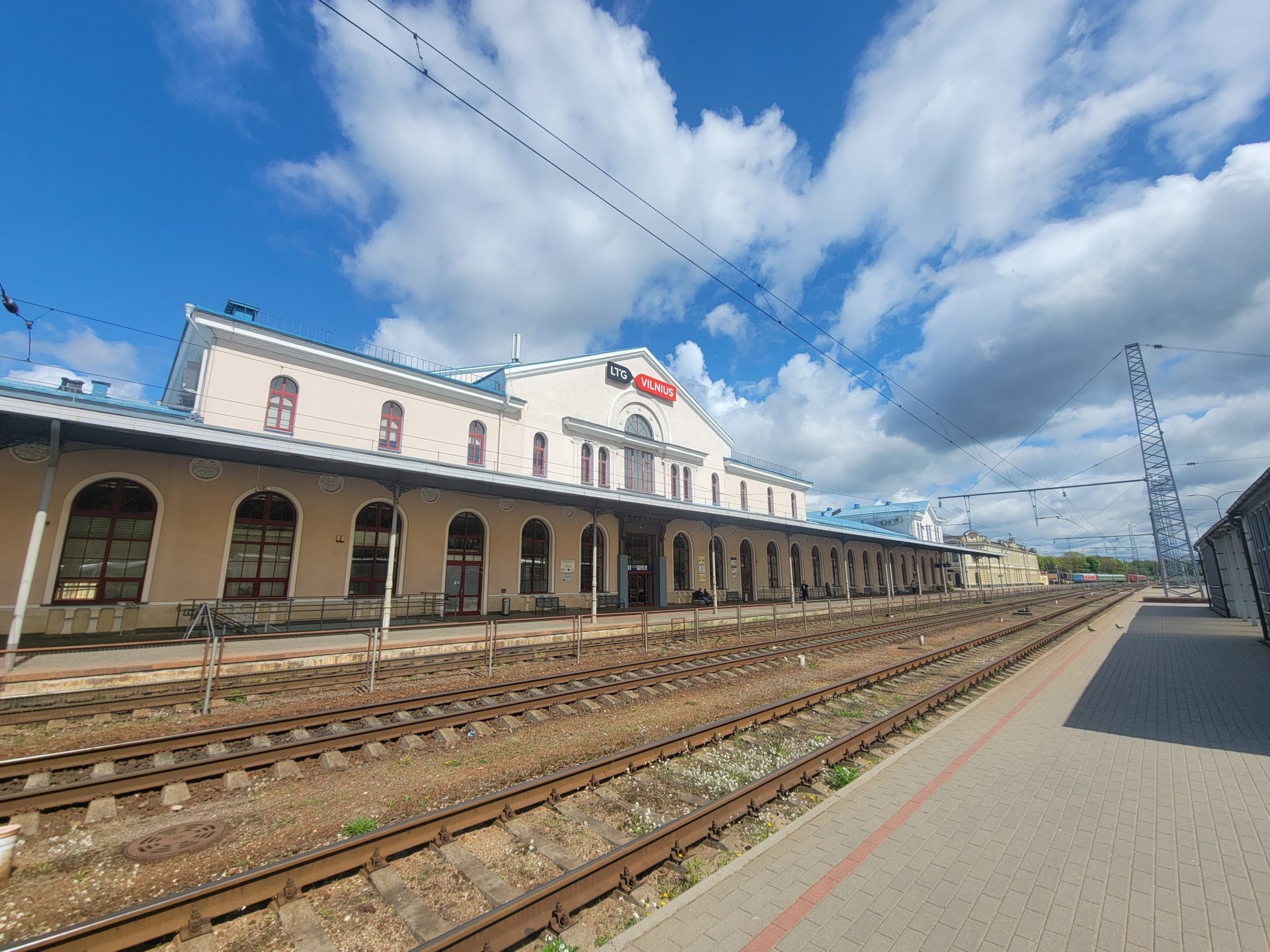 a train station with a building and train tracks