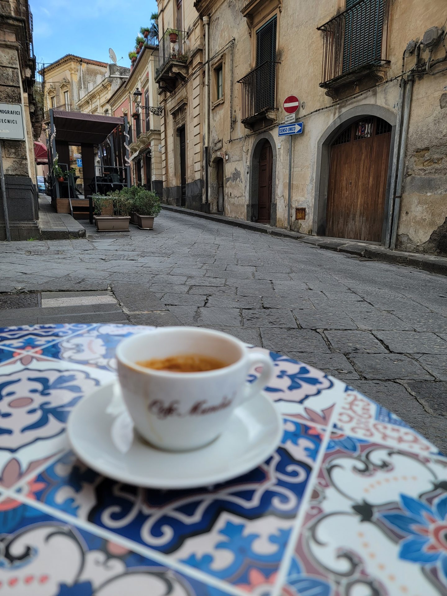 a cup of coffee on a table in a street