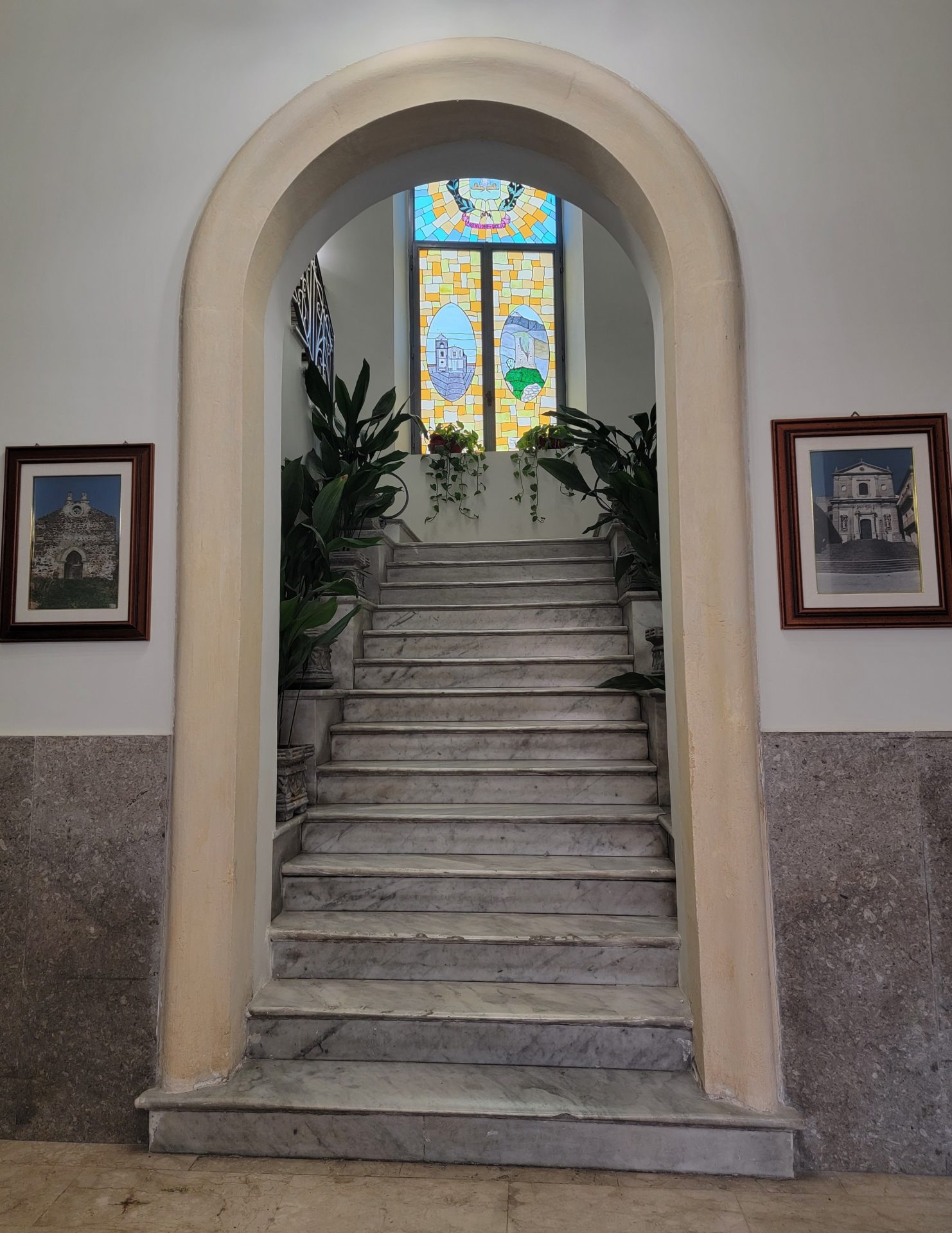 a staircase leading to a stained glass window