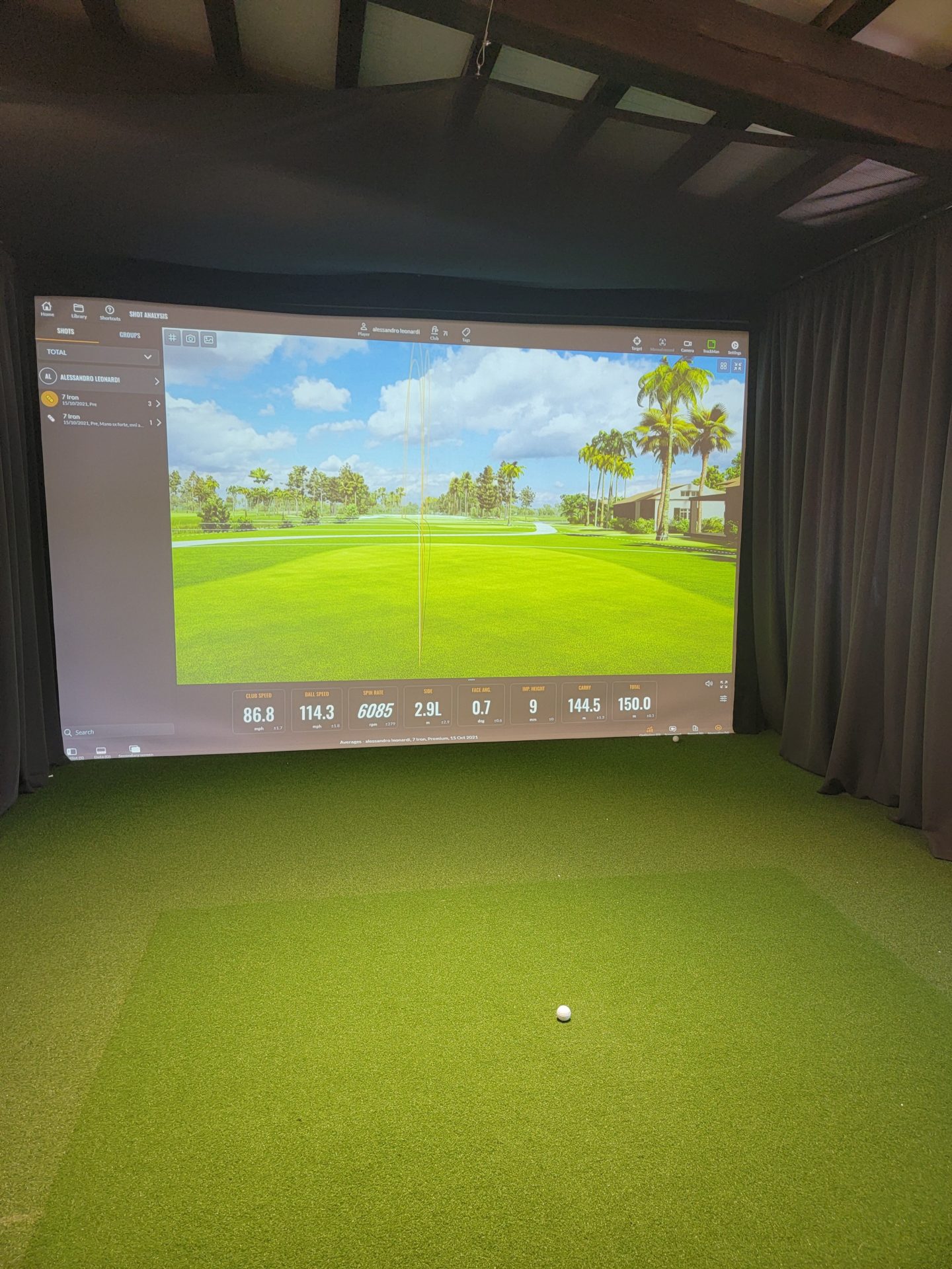 a screen with a golf ball in the middle of a room