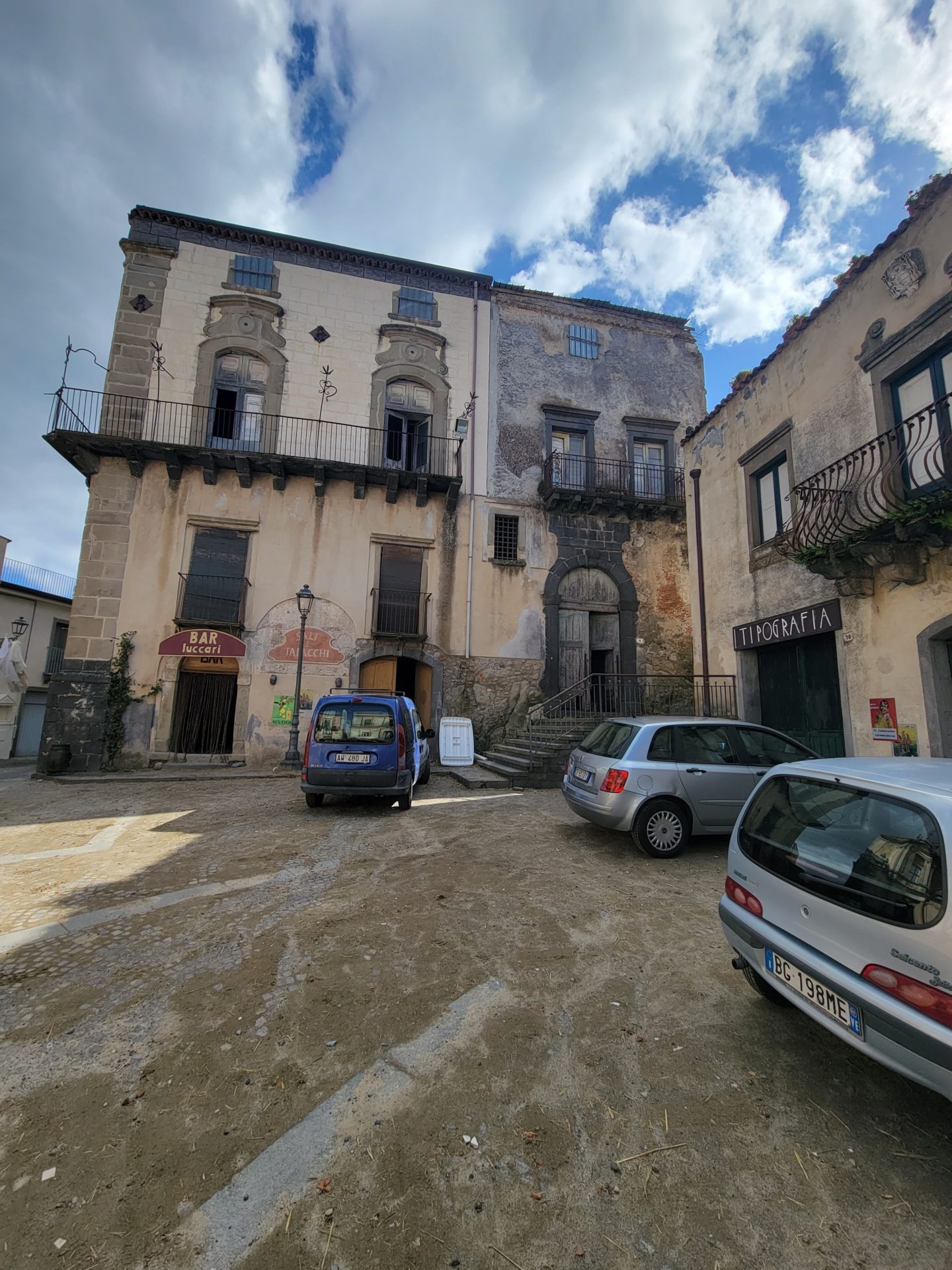 a group of cars parked in a courtyard of a building