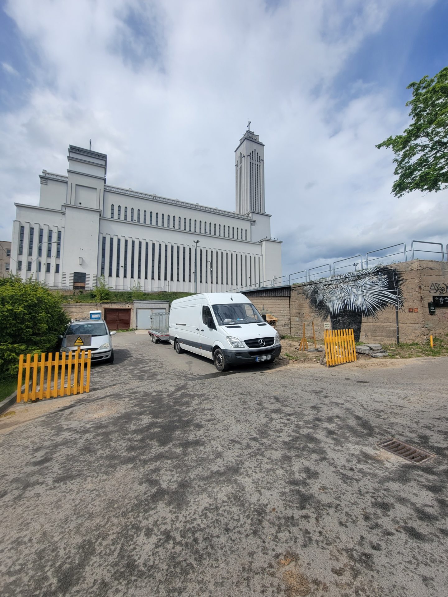 a white building with a white van parked in front of it