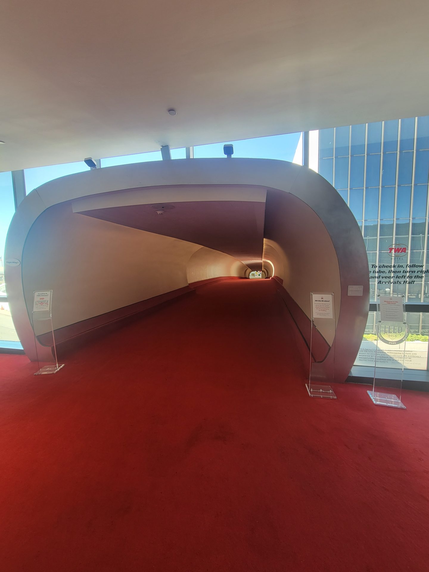 a tunnel with red carpet and signs