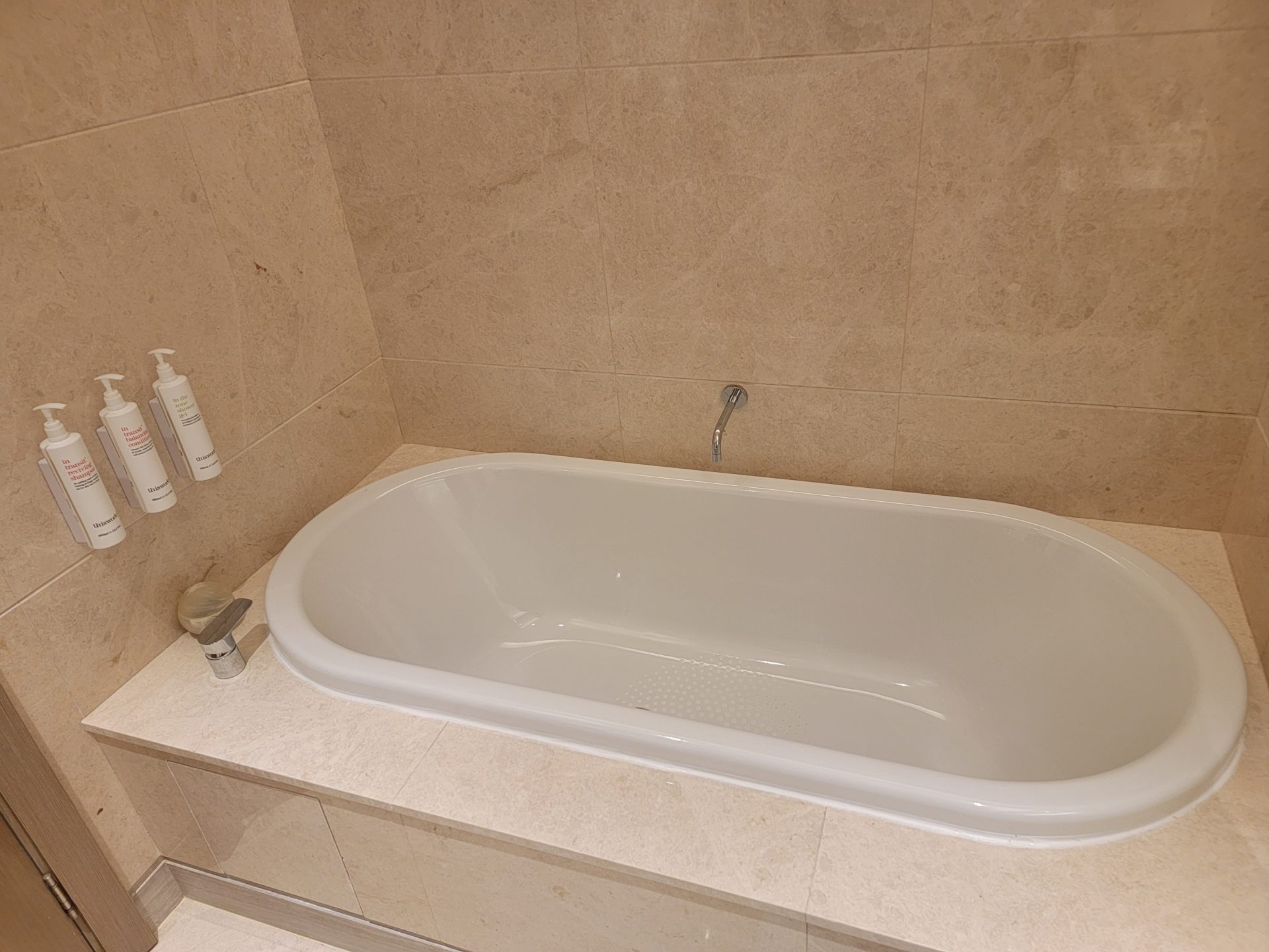 a white bathtub in a bathroom