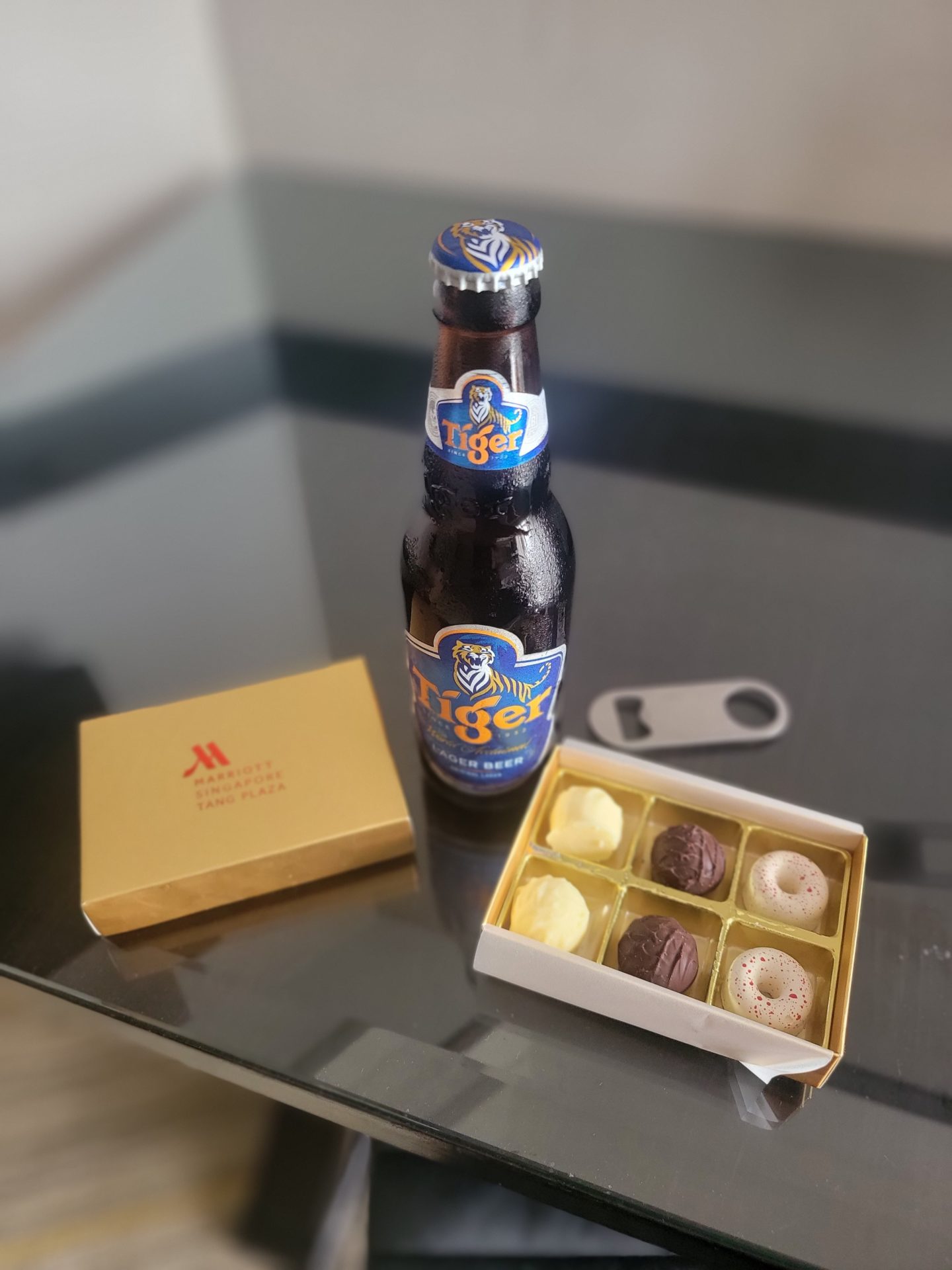 a bottle of beer next to a box of chocolates
