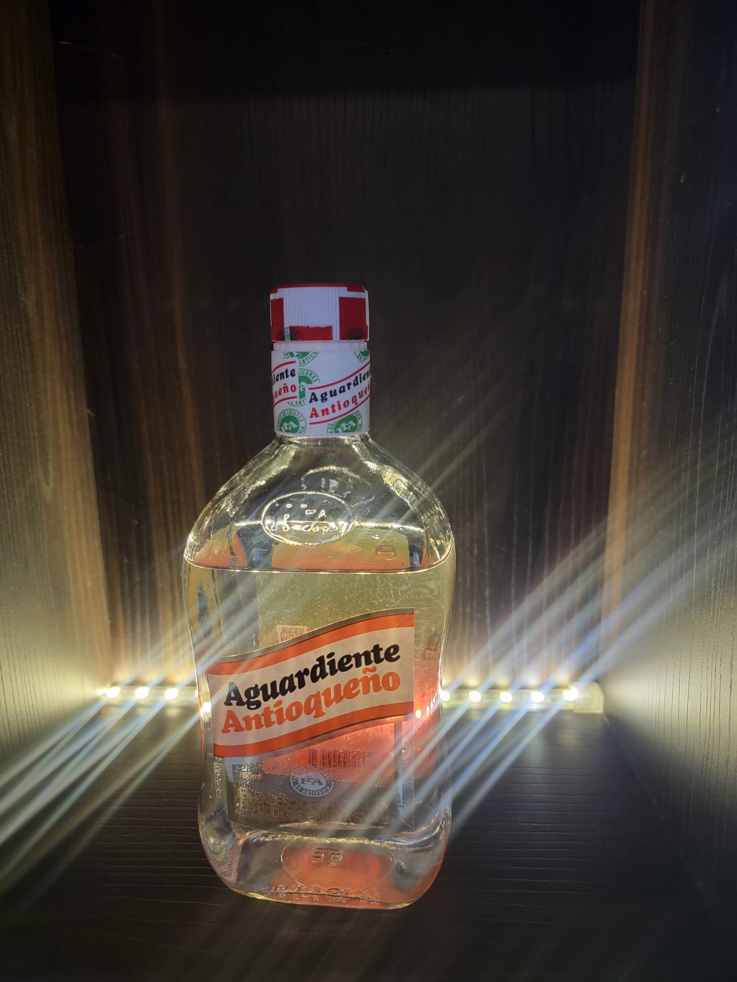 a bottle of alcohol in a dark room
