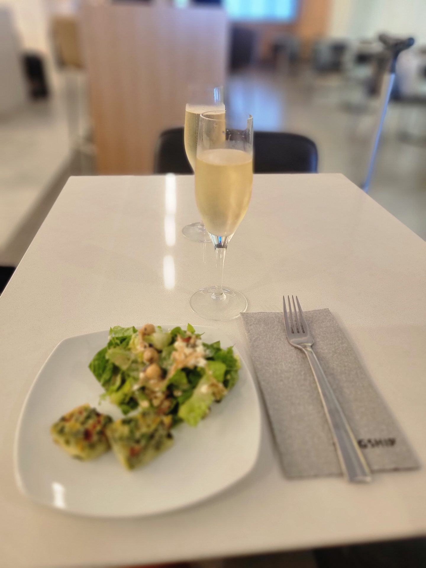 a plate of salad and a glass of champagne