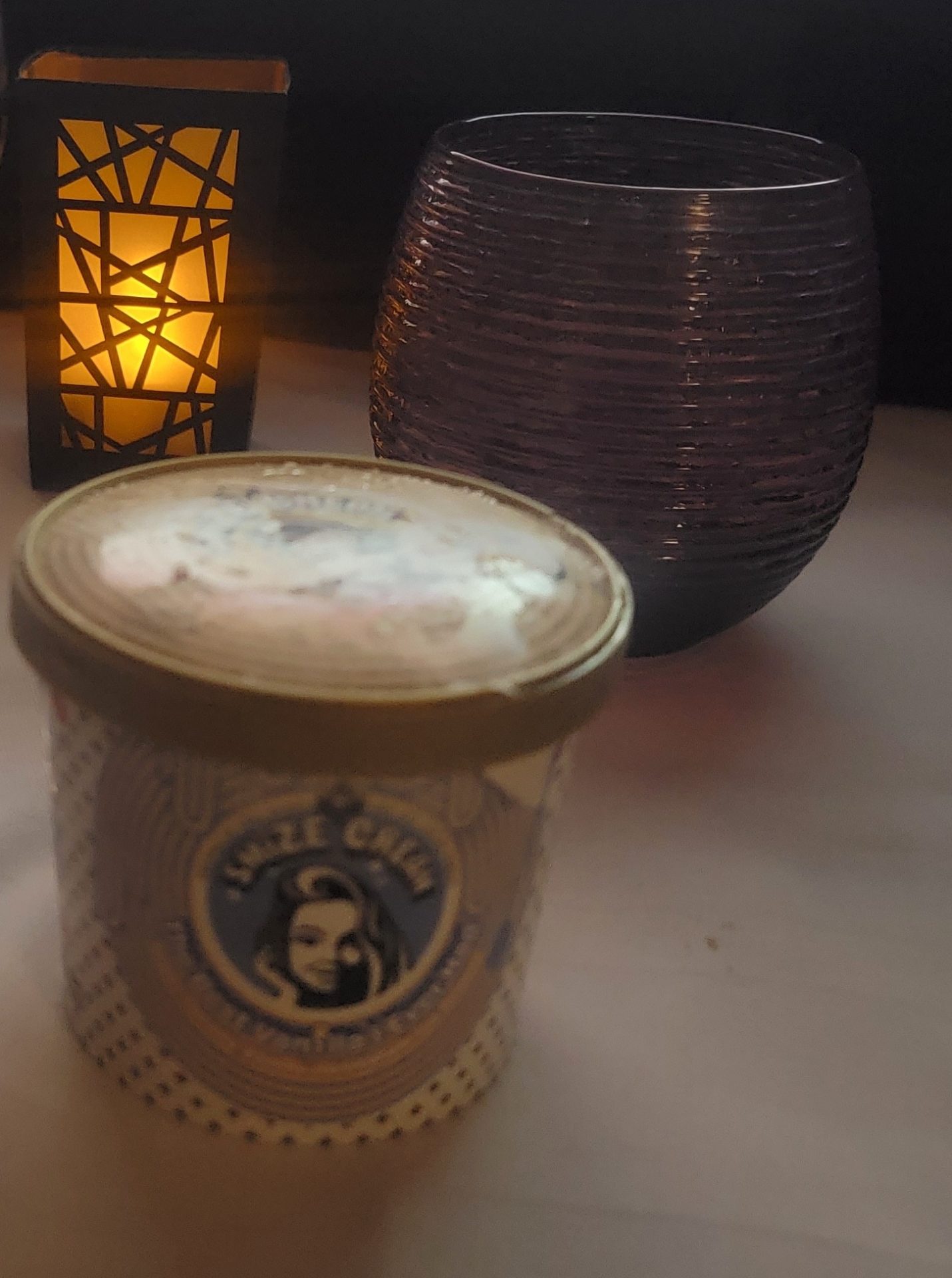 a cup of ice cream and a candle
