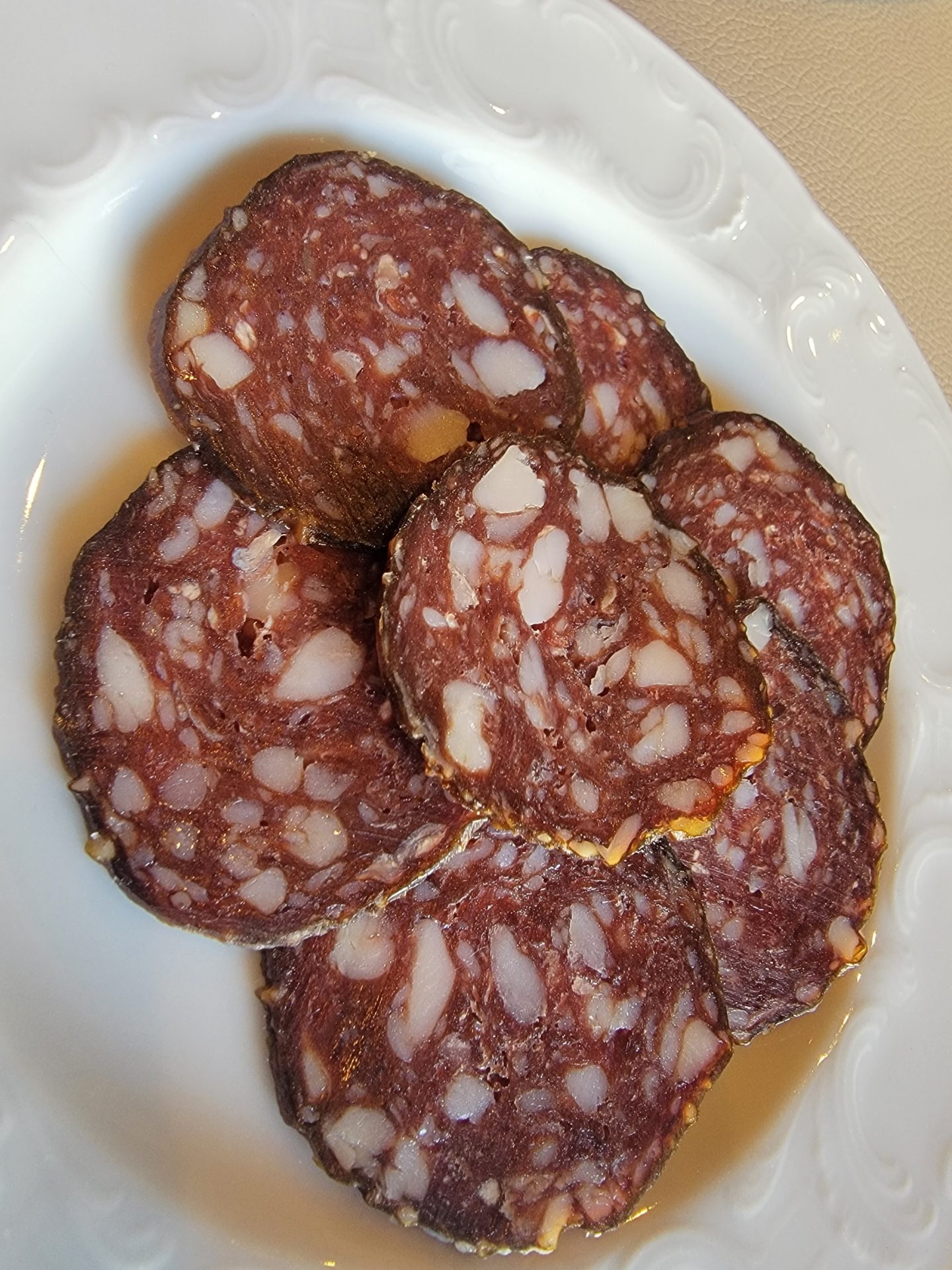 a plate of sliced sausage