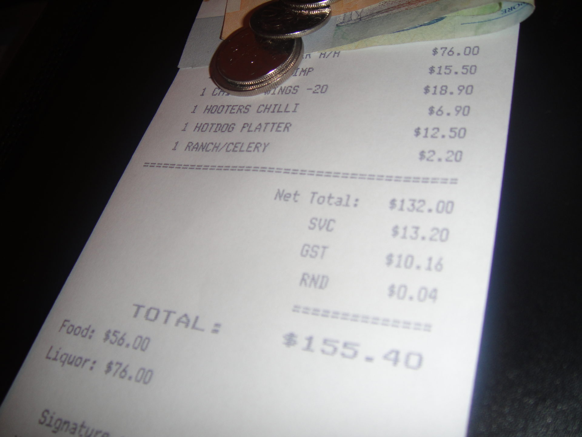a receipt with coins and a few coins on it