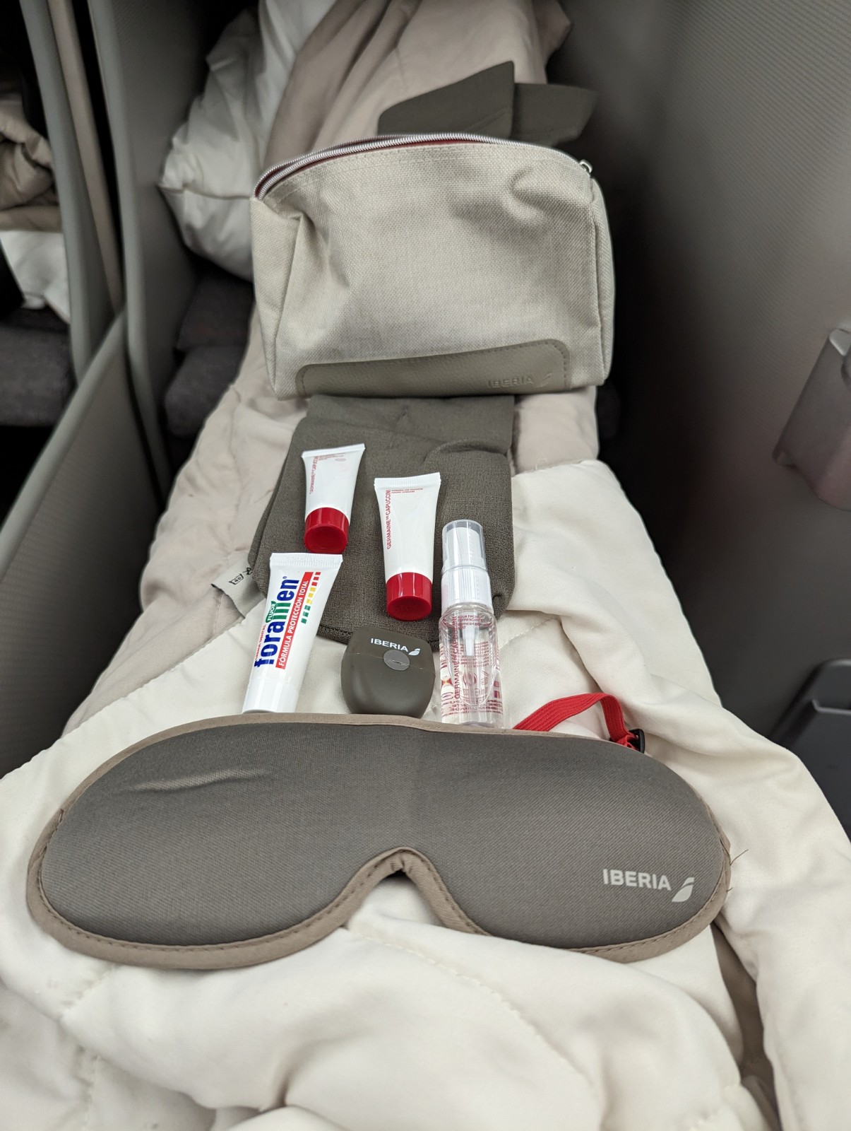 a set of travel items on a bed