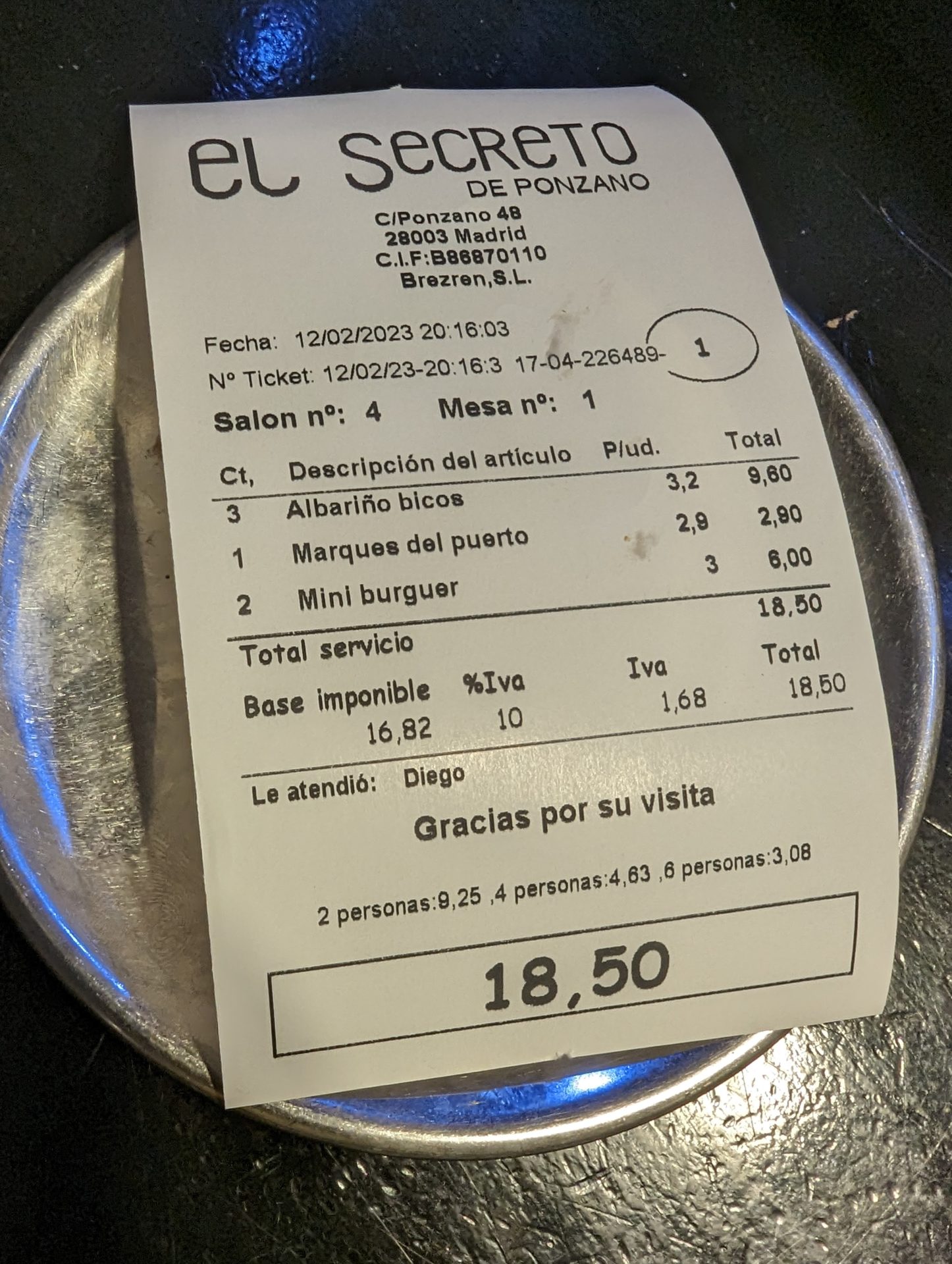 a receipt on a metal plate