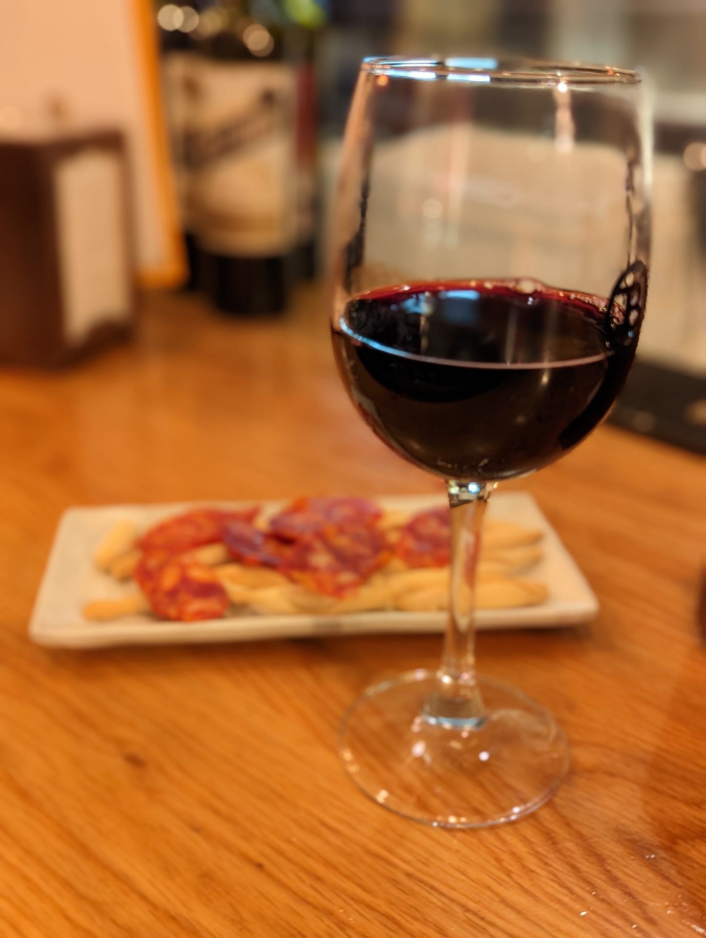 a glass of red wine on a table