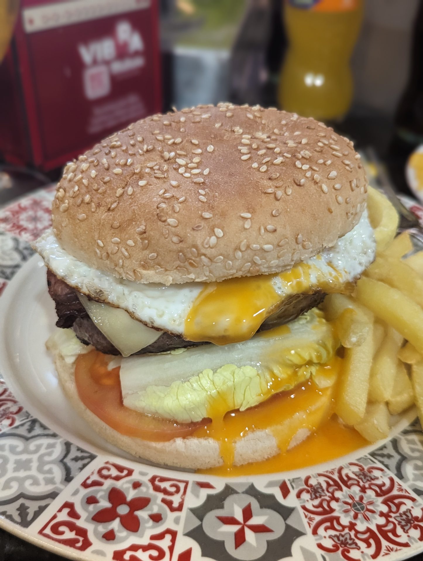 a burger with a egg and fries on a plate