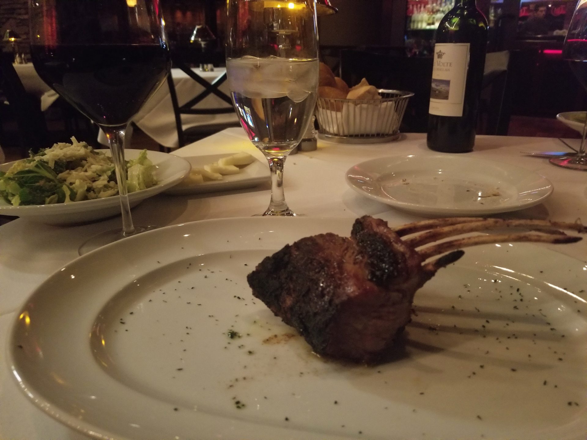 a plate of meat and wine on a table