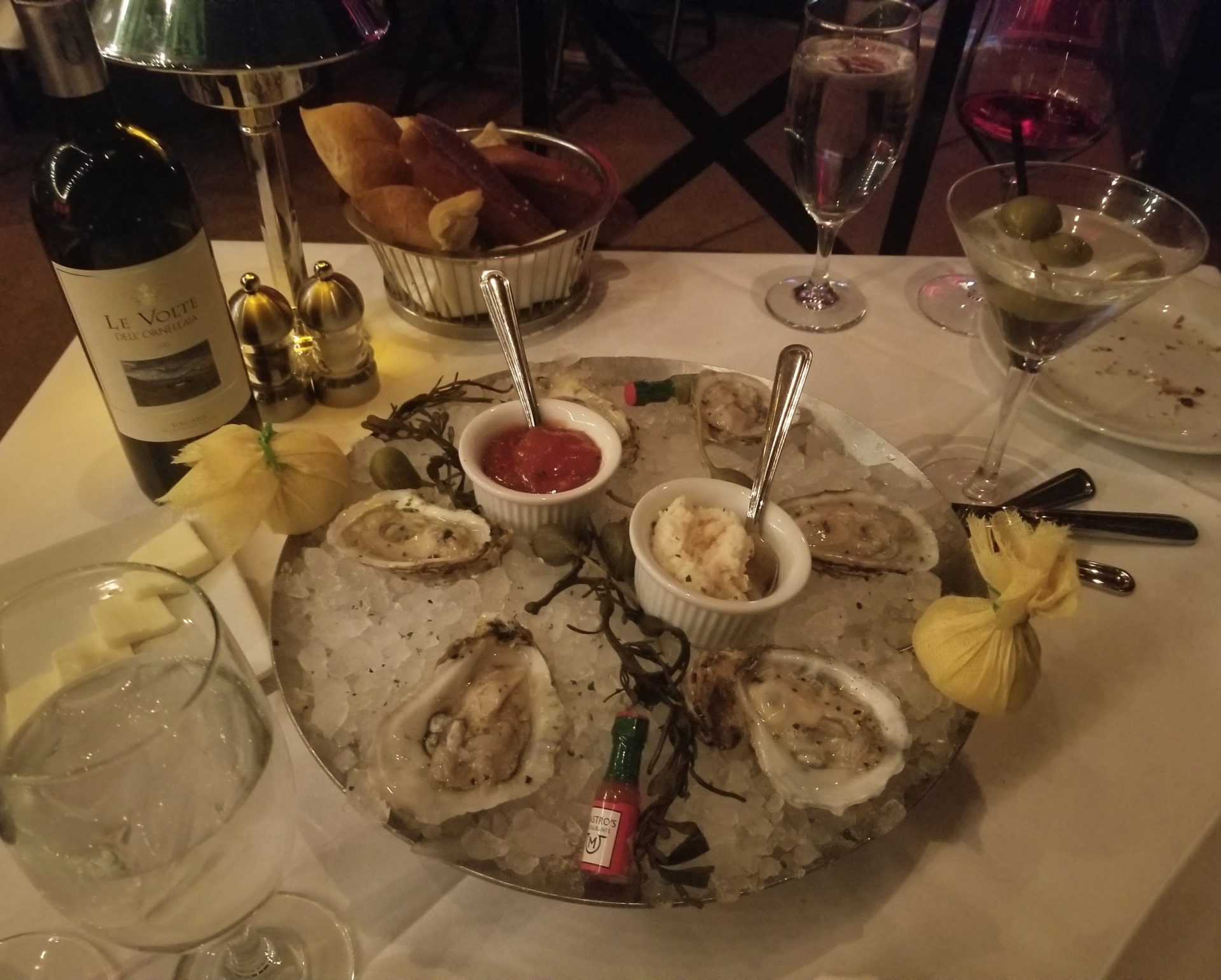 a plate of oysters and a bottle of wine