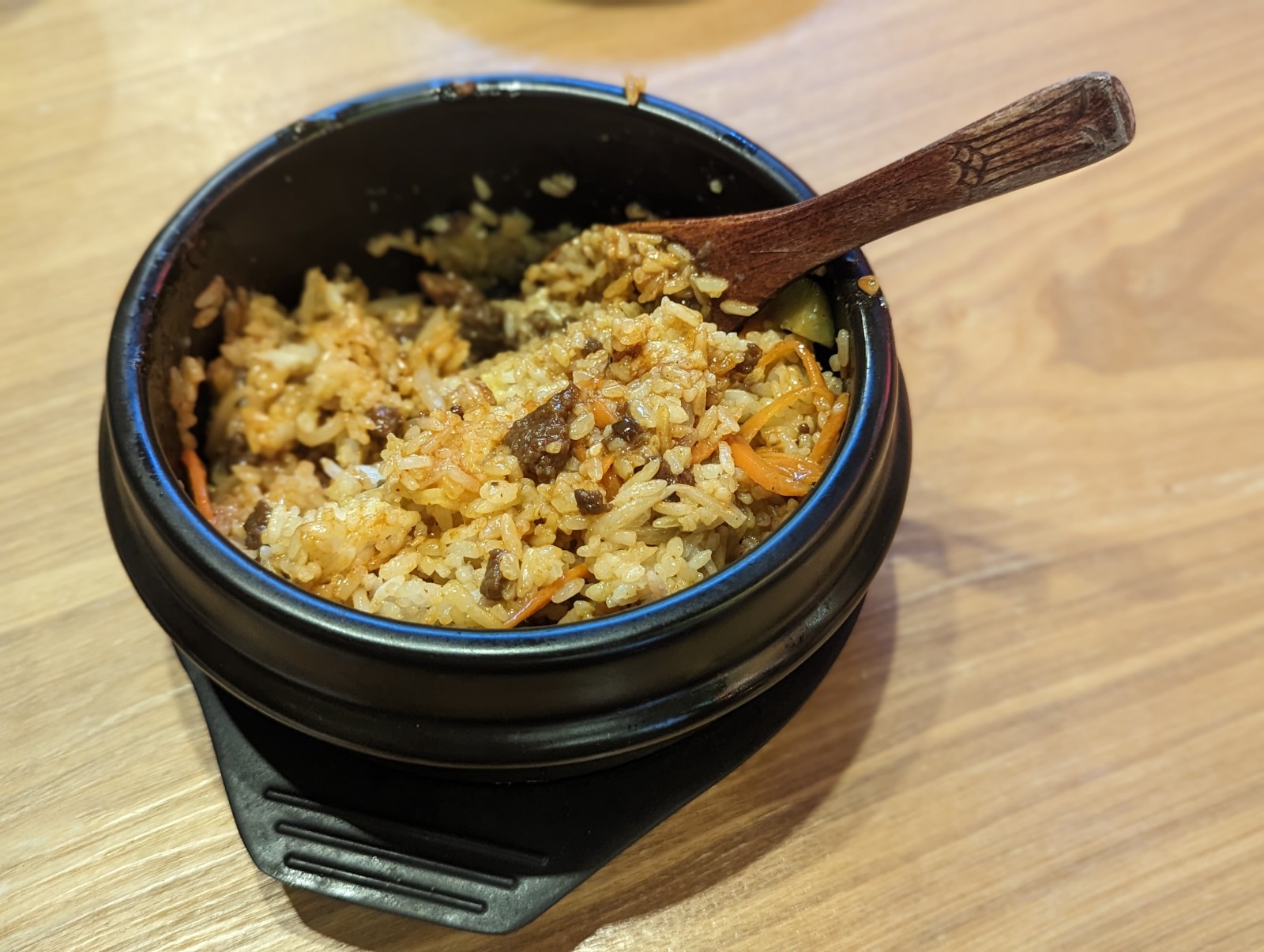 a bowl of rice with a wooden spoon