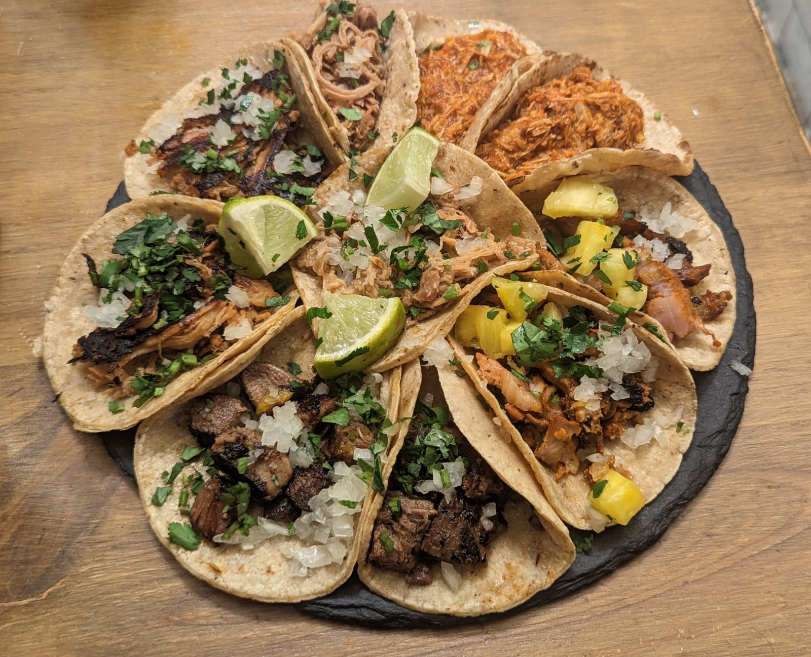 a plate of tacos on a wood table