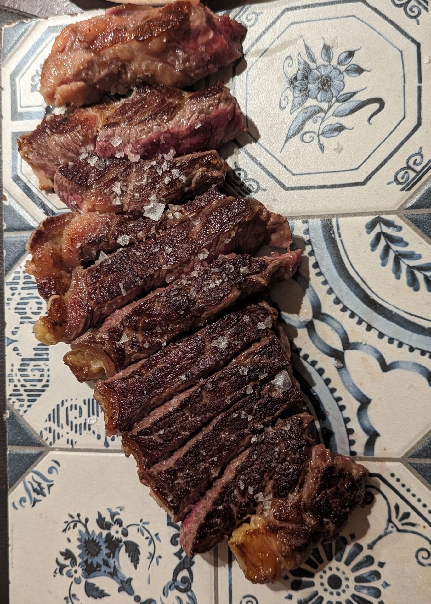 a sliced steak on a tile surface