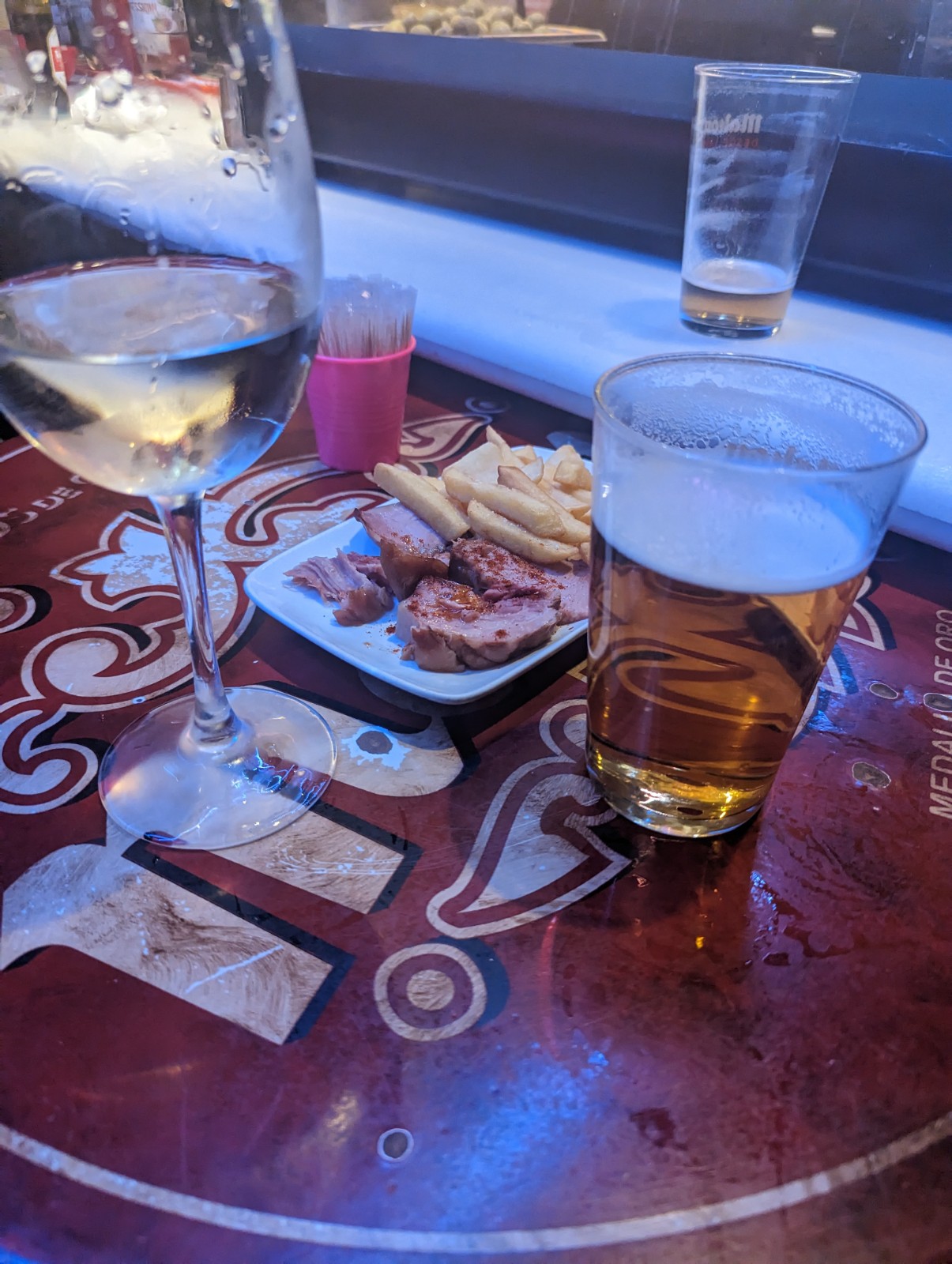 a plate of food and a glass of beer on a table