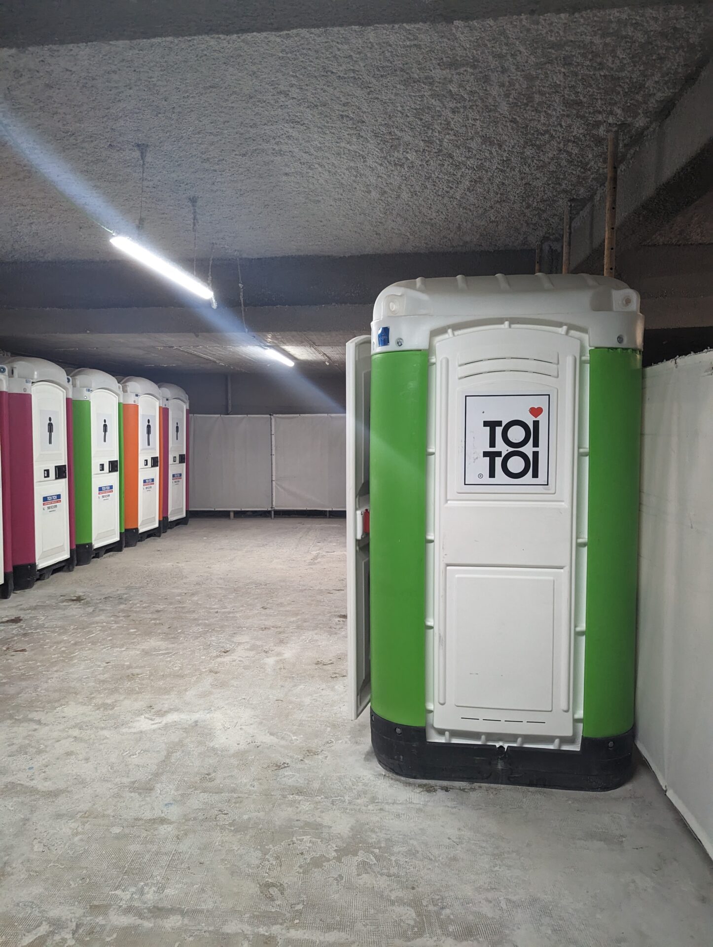a row of portable toilets in a room