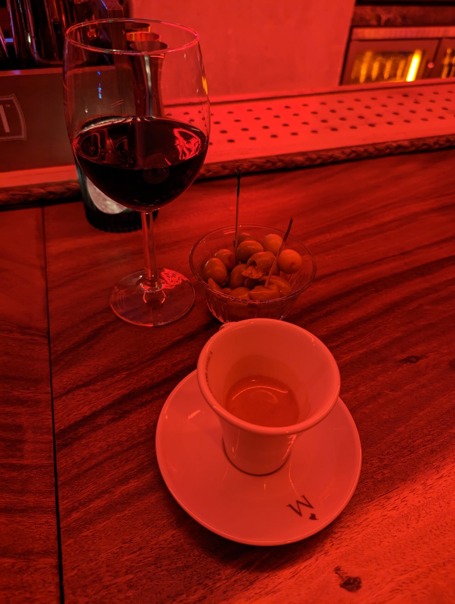 a glass of wine and a cup of wine on a table