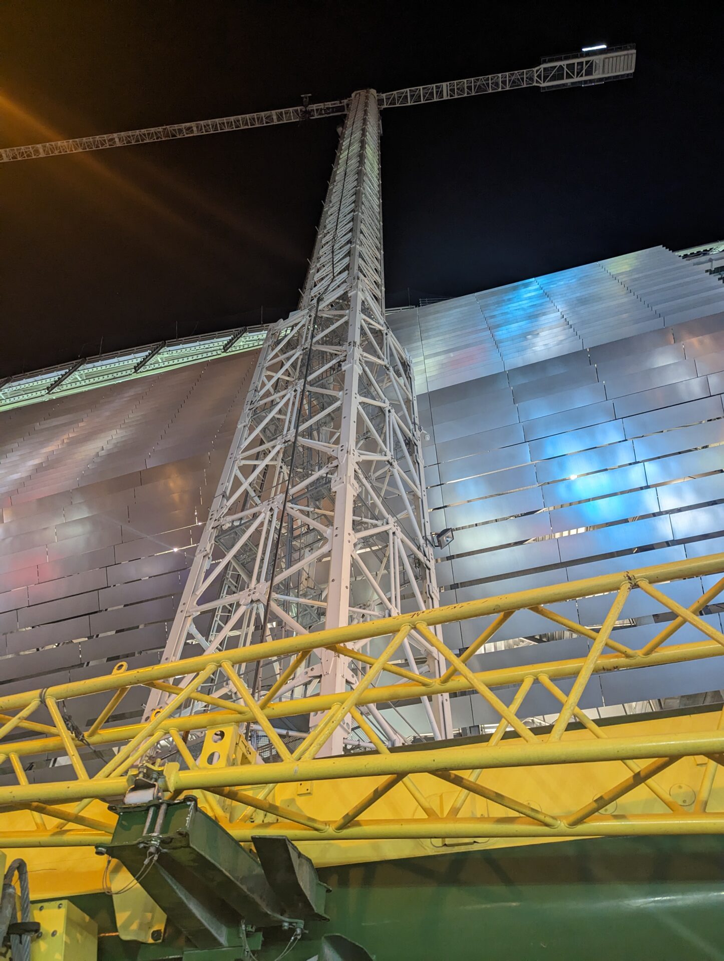 a metal tower with a yellow railing