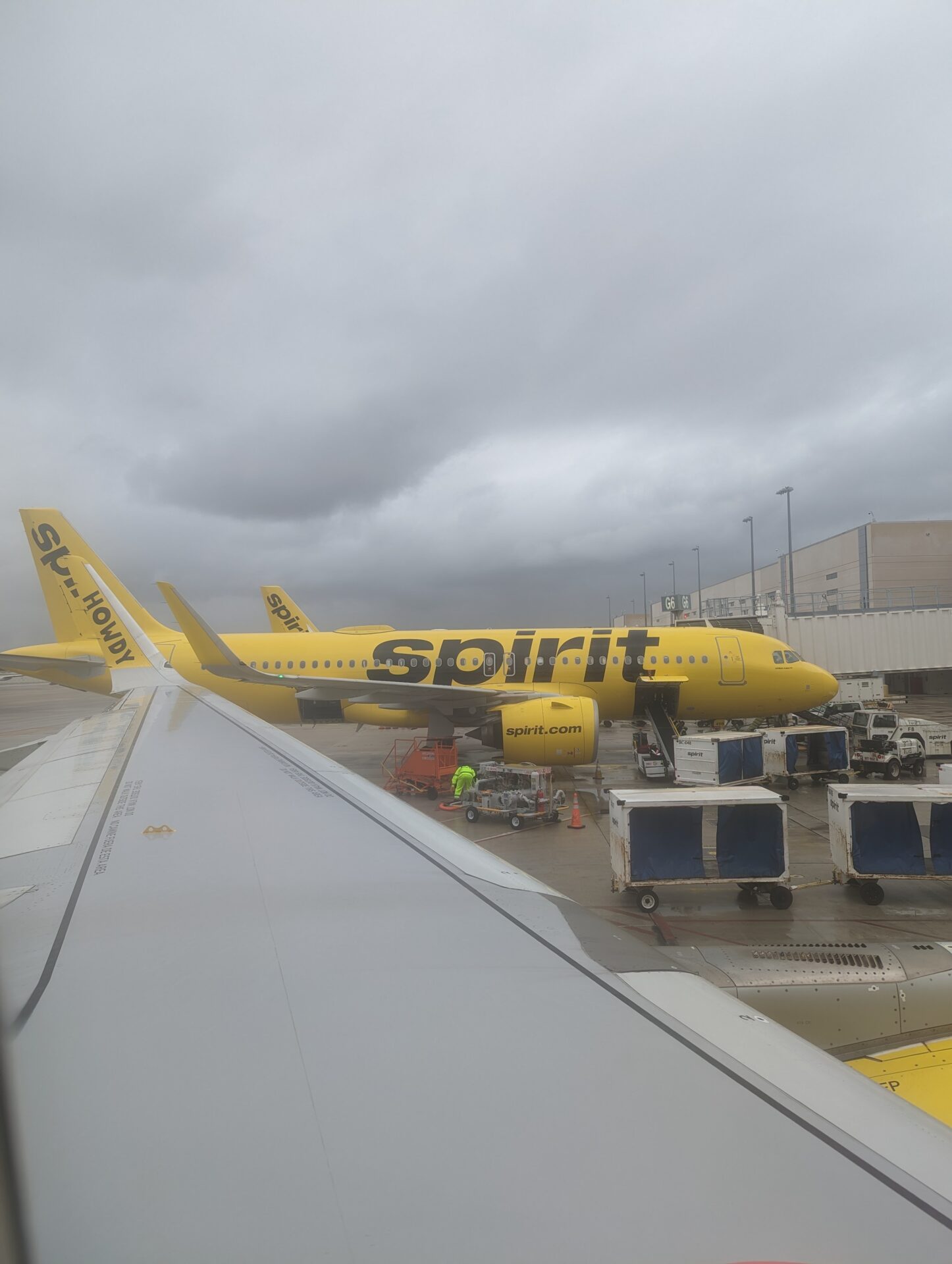 a yellow airplane parked at an airport